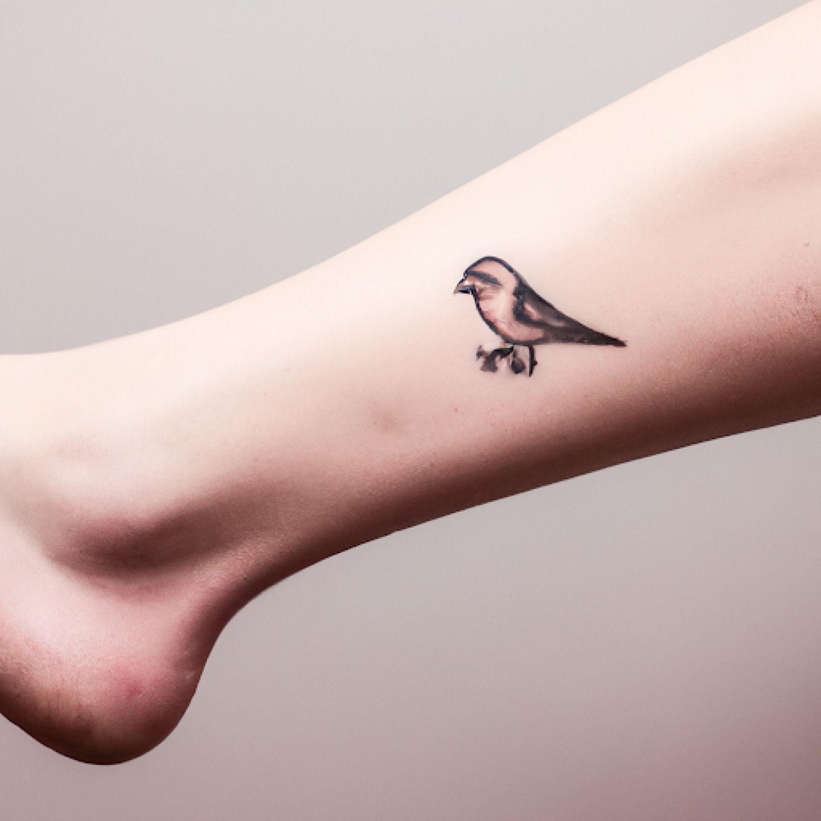Bird tattoo on ankle for women