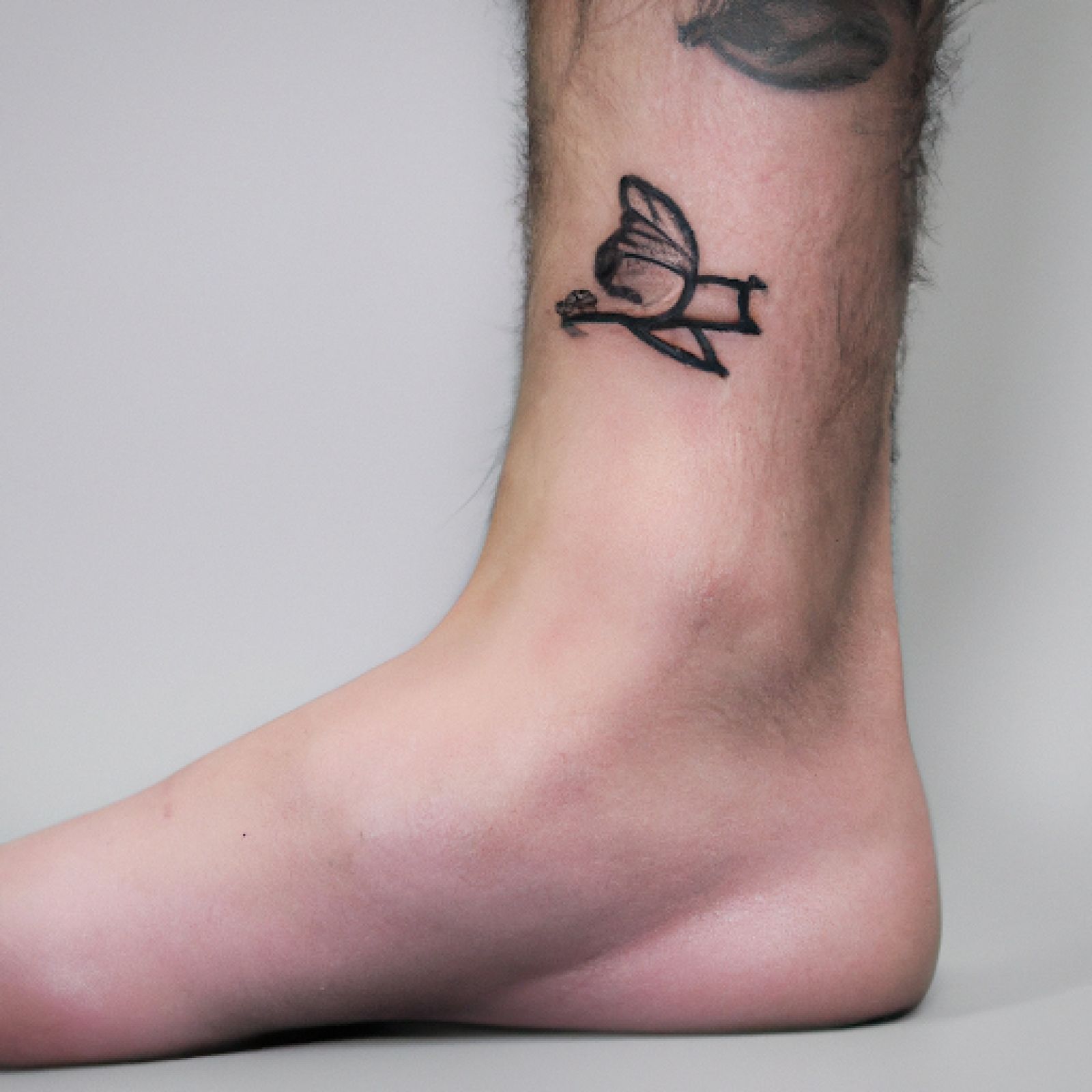 Bird tattoo on foot for men