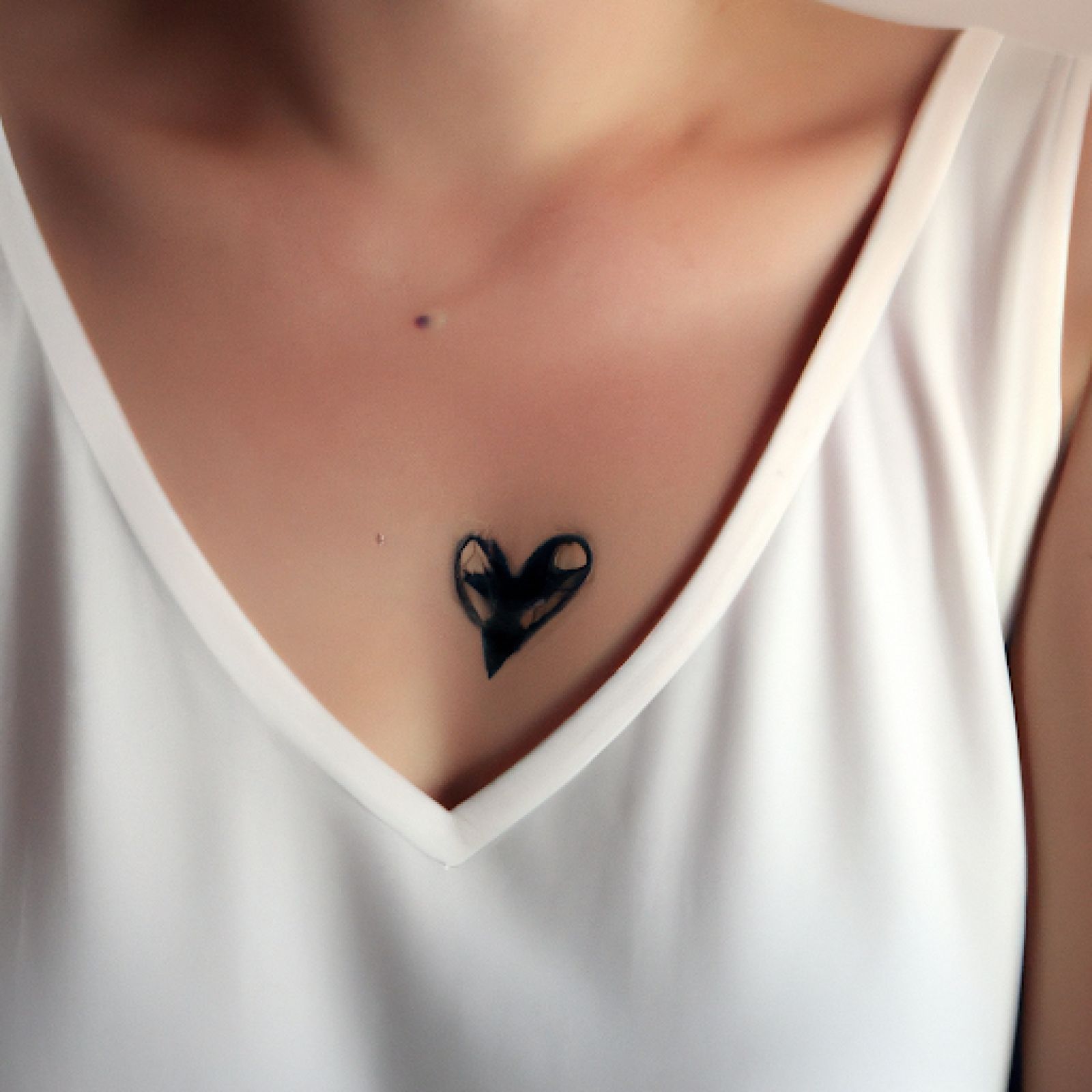 Broken heart tattoo on chest for women