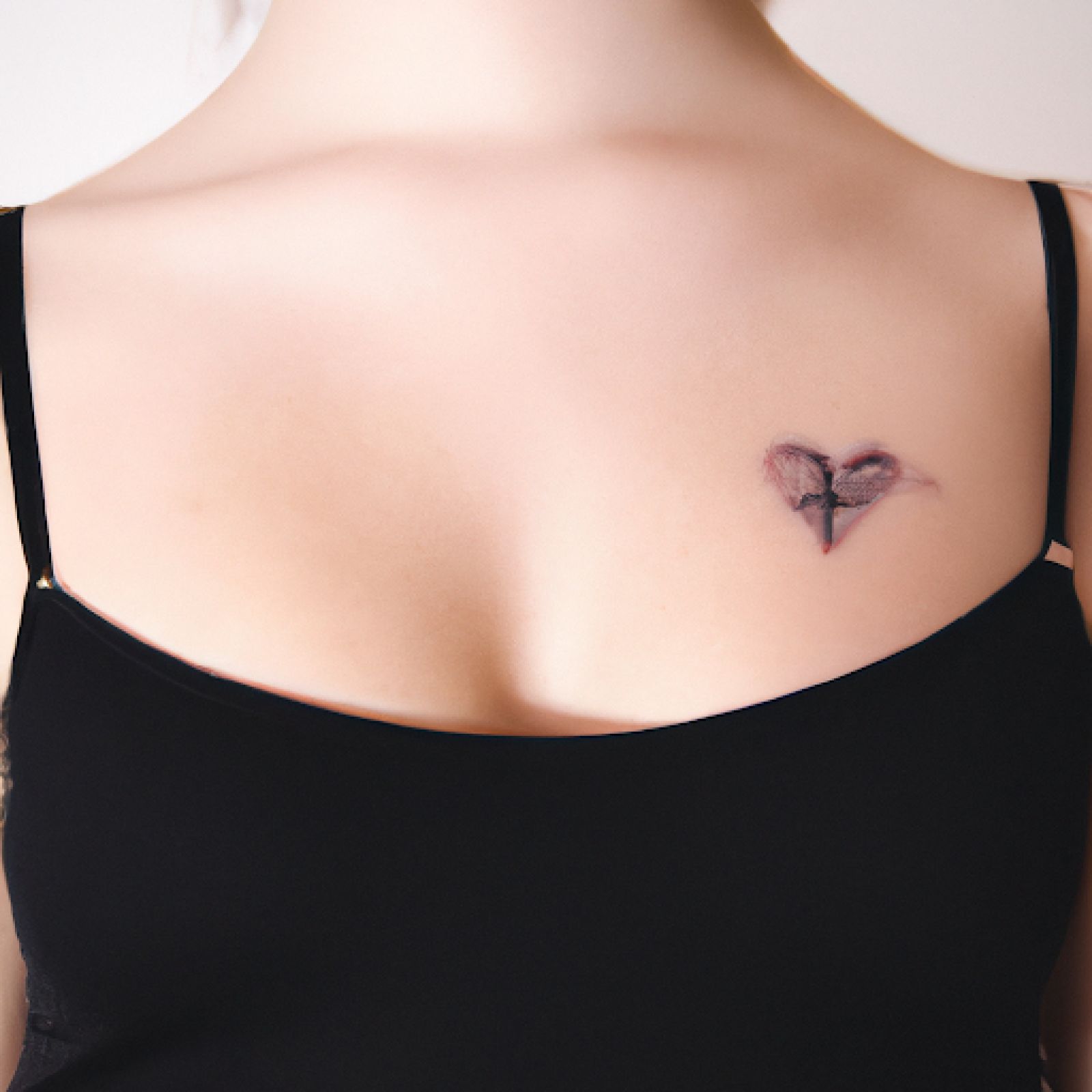 Broken heart tattoo on sternum for women