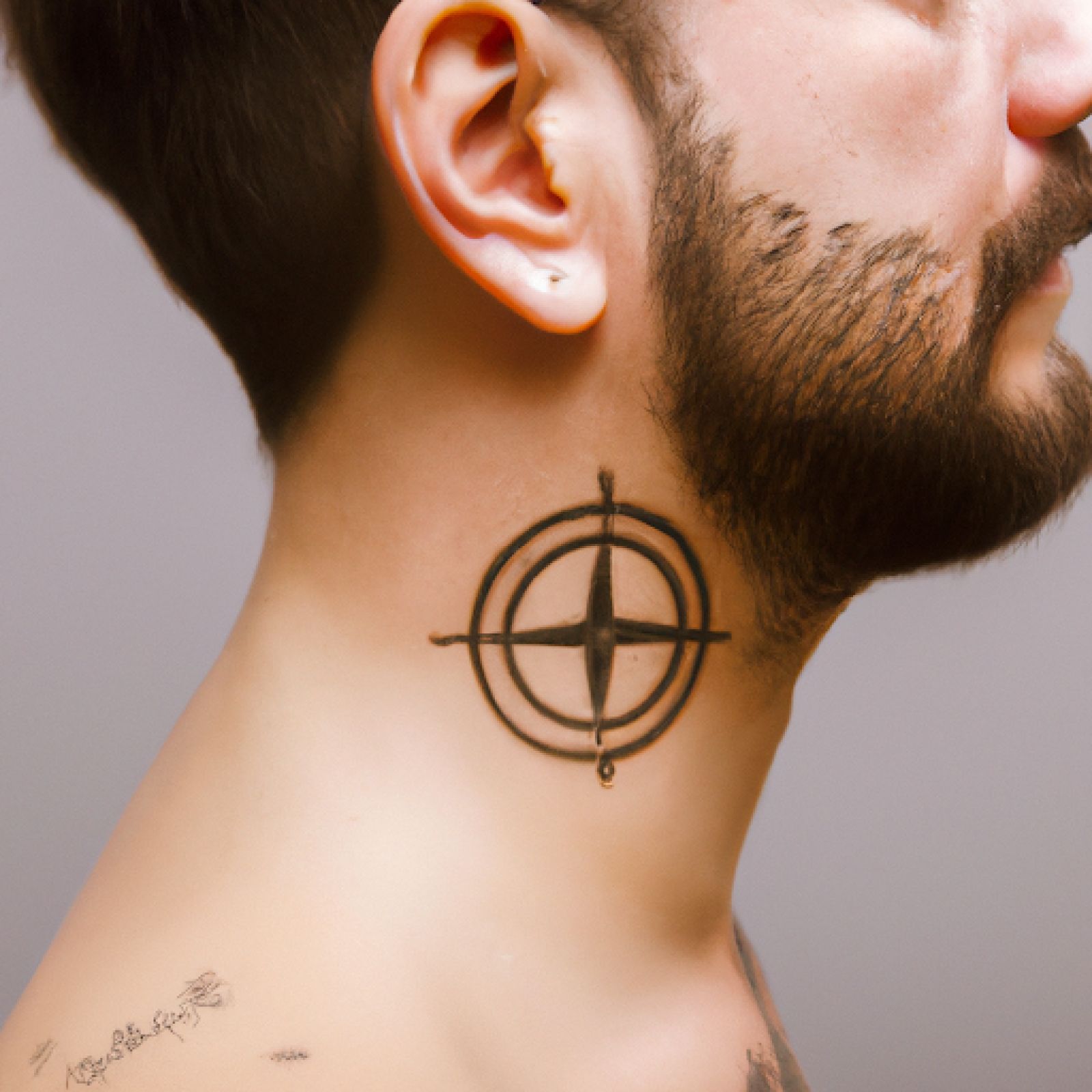 Compass tattoo on neck for men