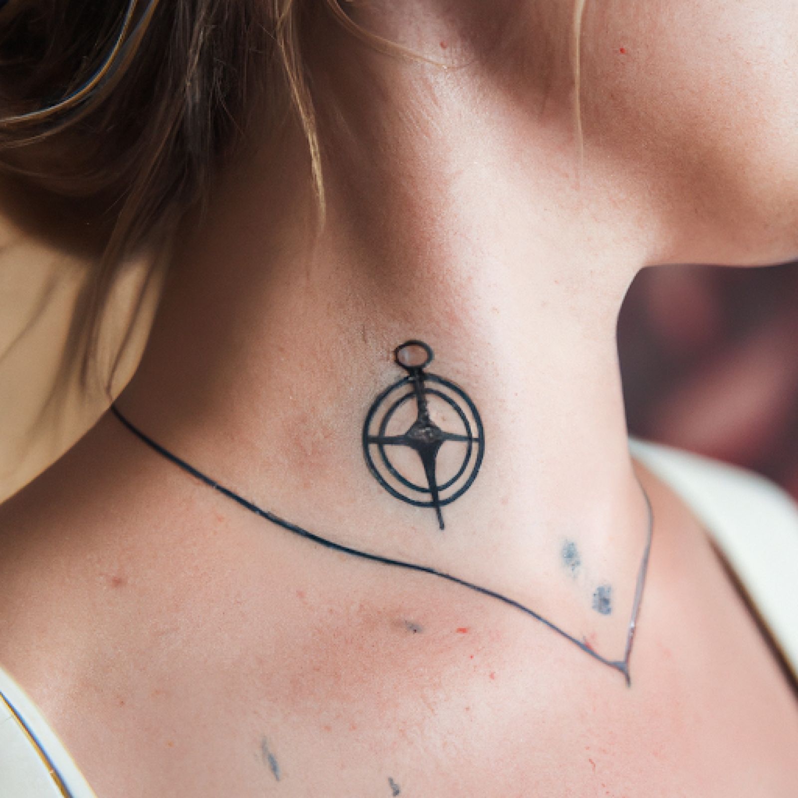 Compass tattoo on neck for women