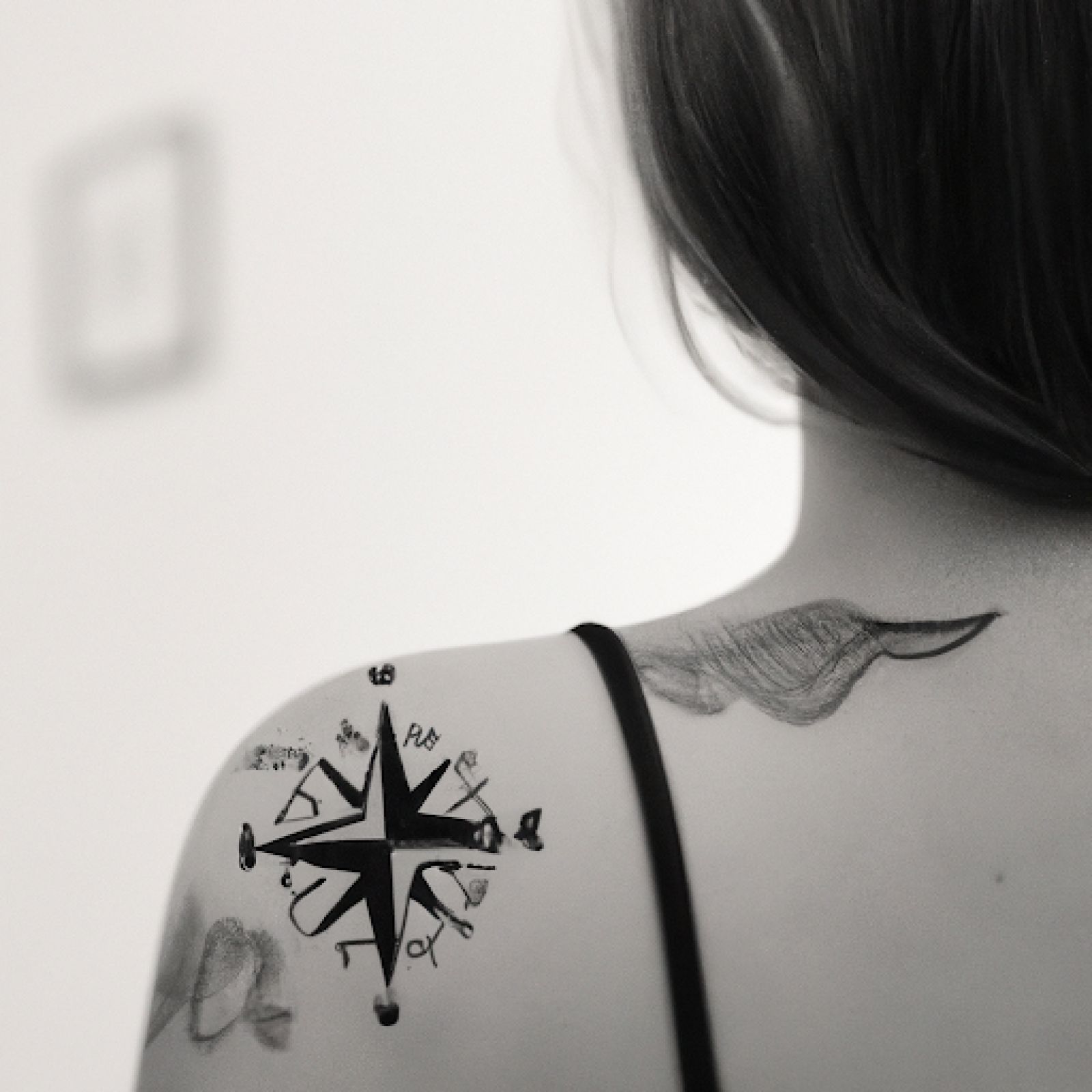 Compass tattoo on shoulder for women
