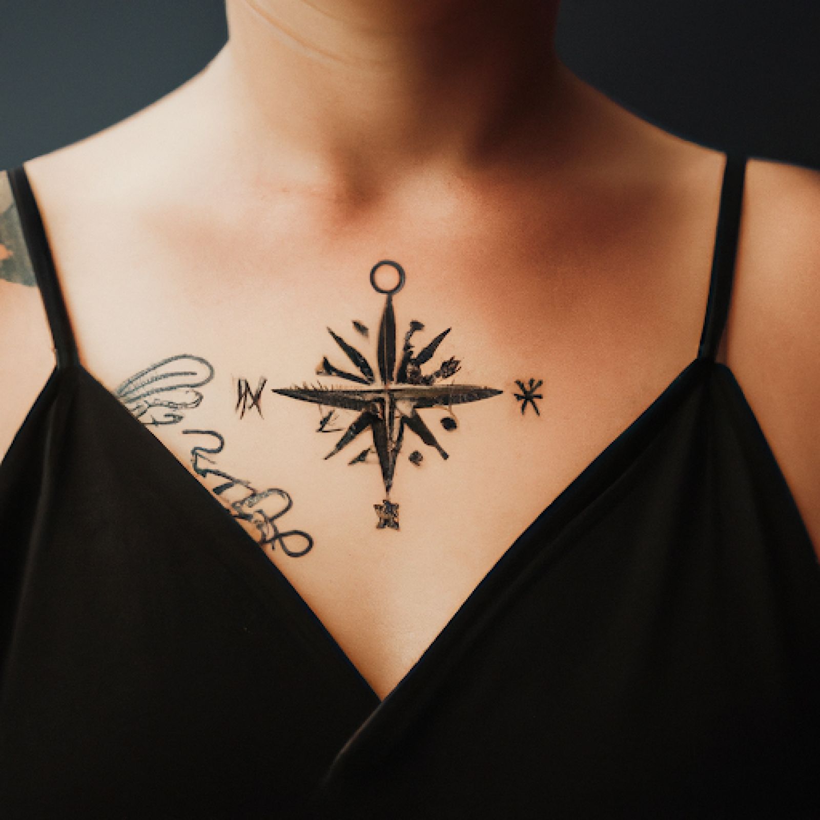 Compass tattoo on sternum for women