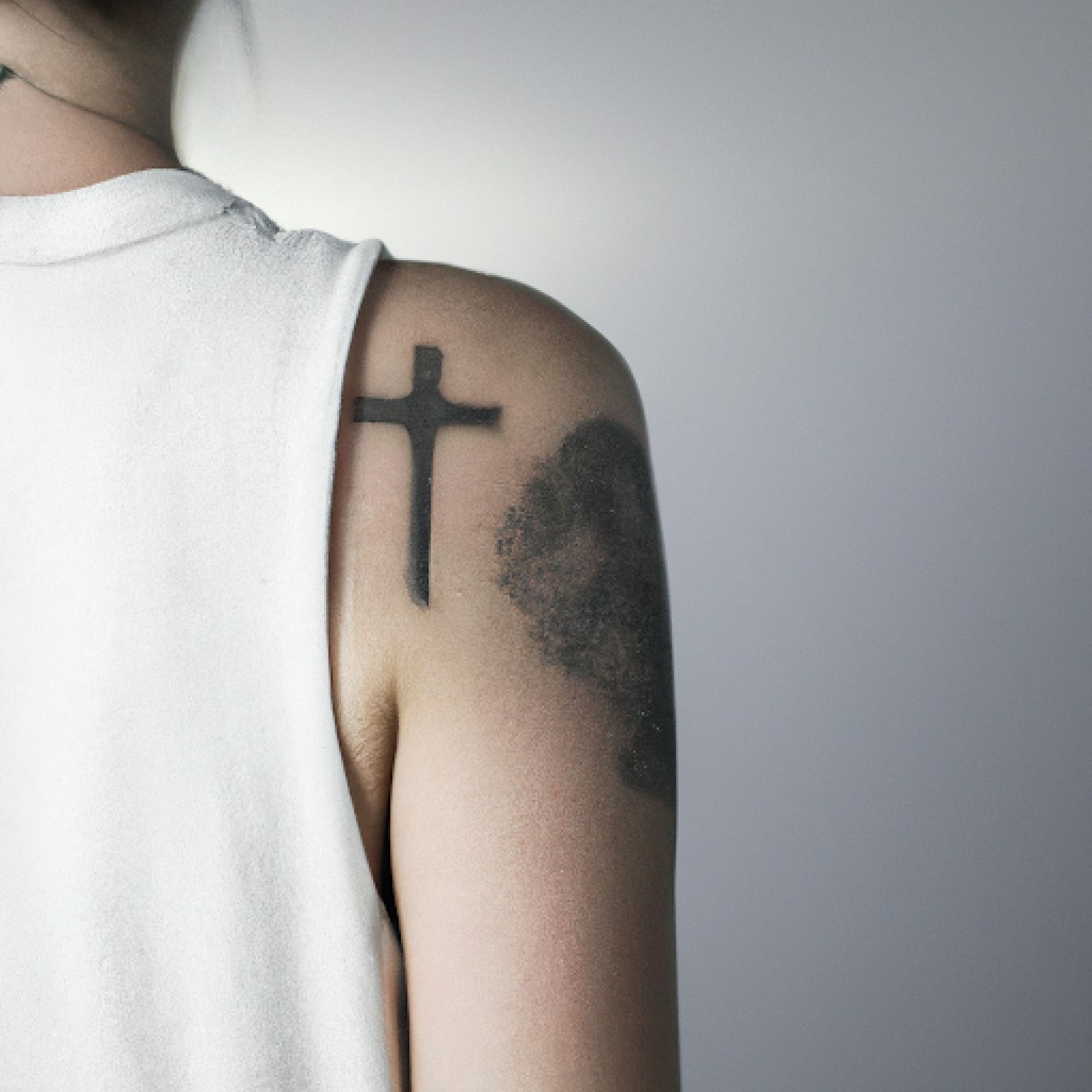 Cross tattoo on arm for women