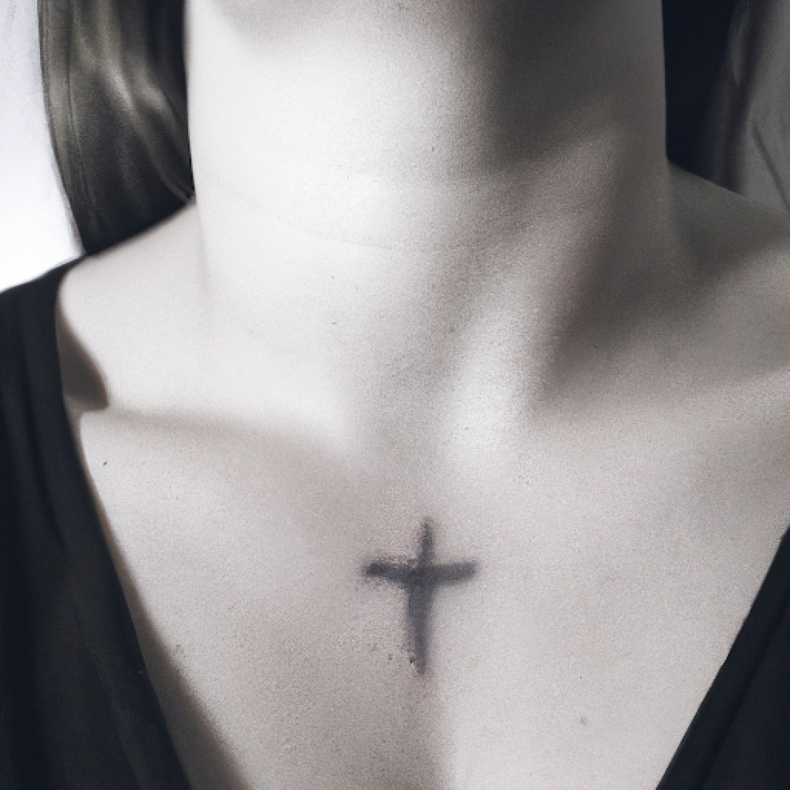 Cross tattoo on chest for women