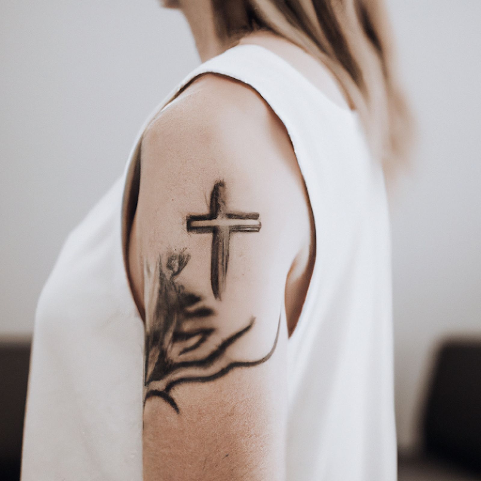 Cross tattoo on half sleeve for women