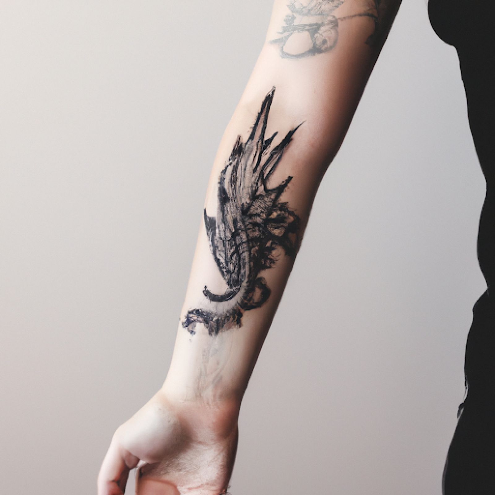 Dragon tattoo on arm for women