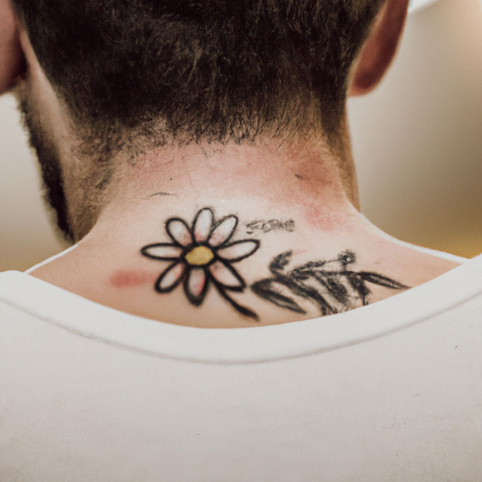 Flower tattoo on back for men