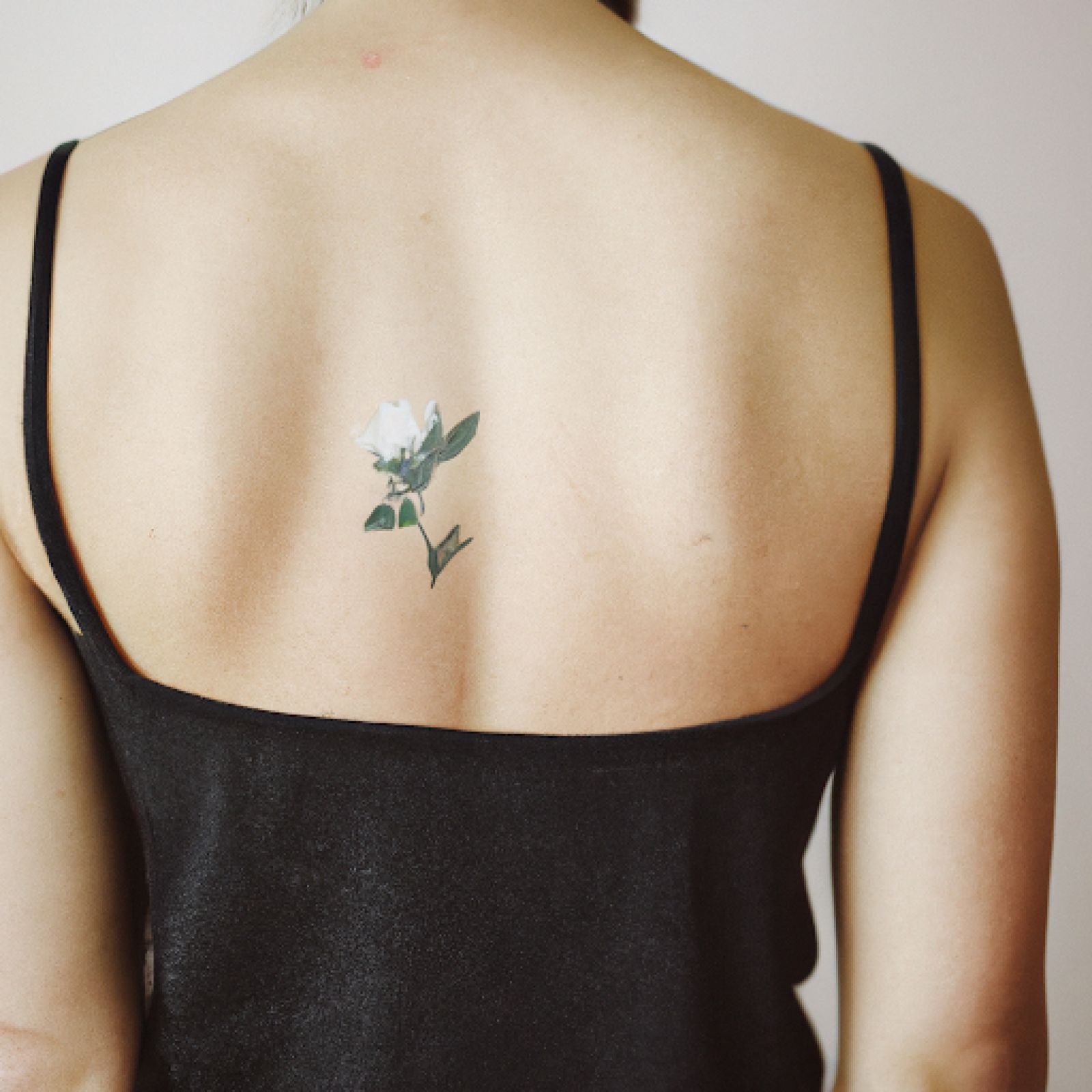 Flower tattoo on back for women