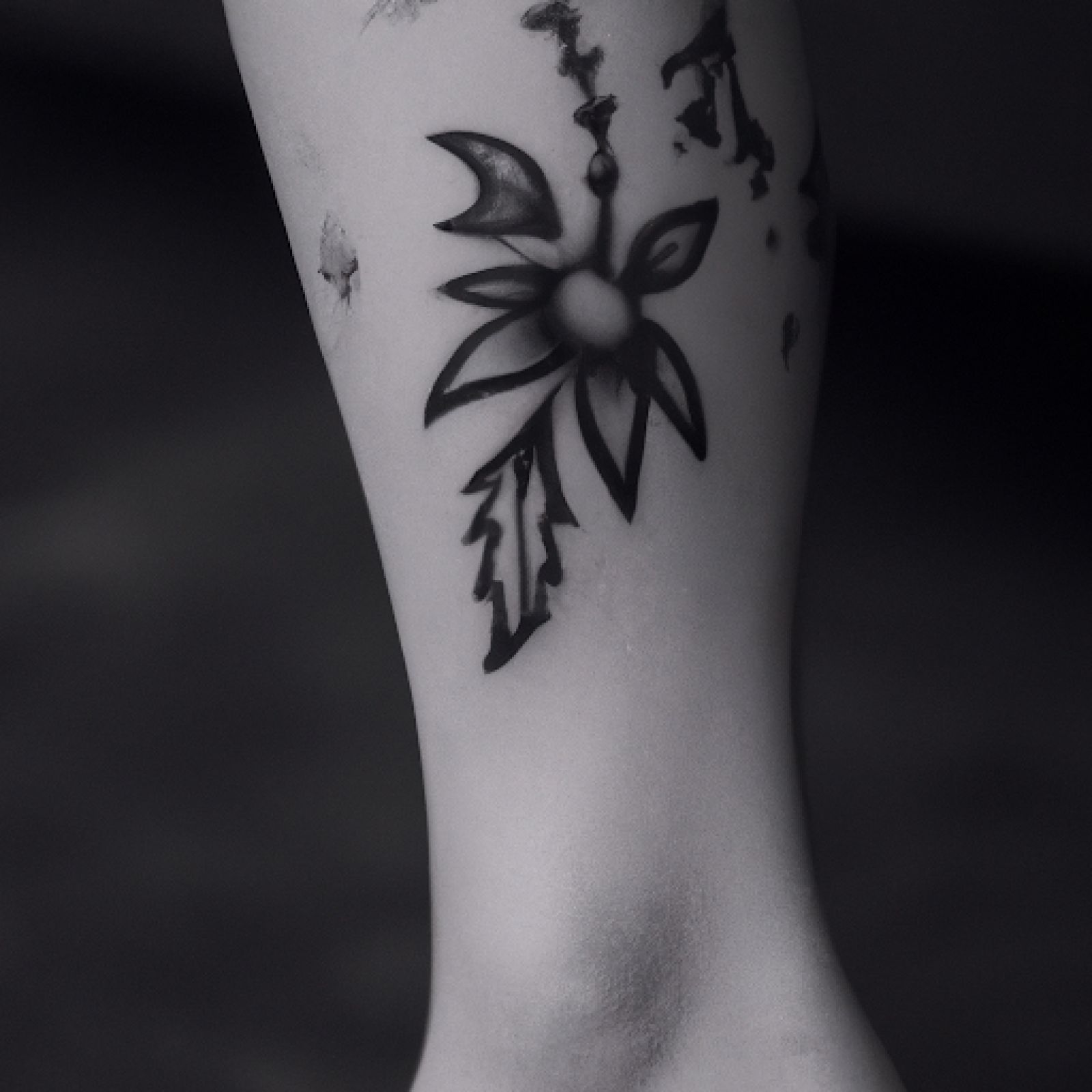 Flower tattoo on calf for women