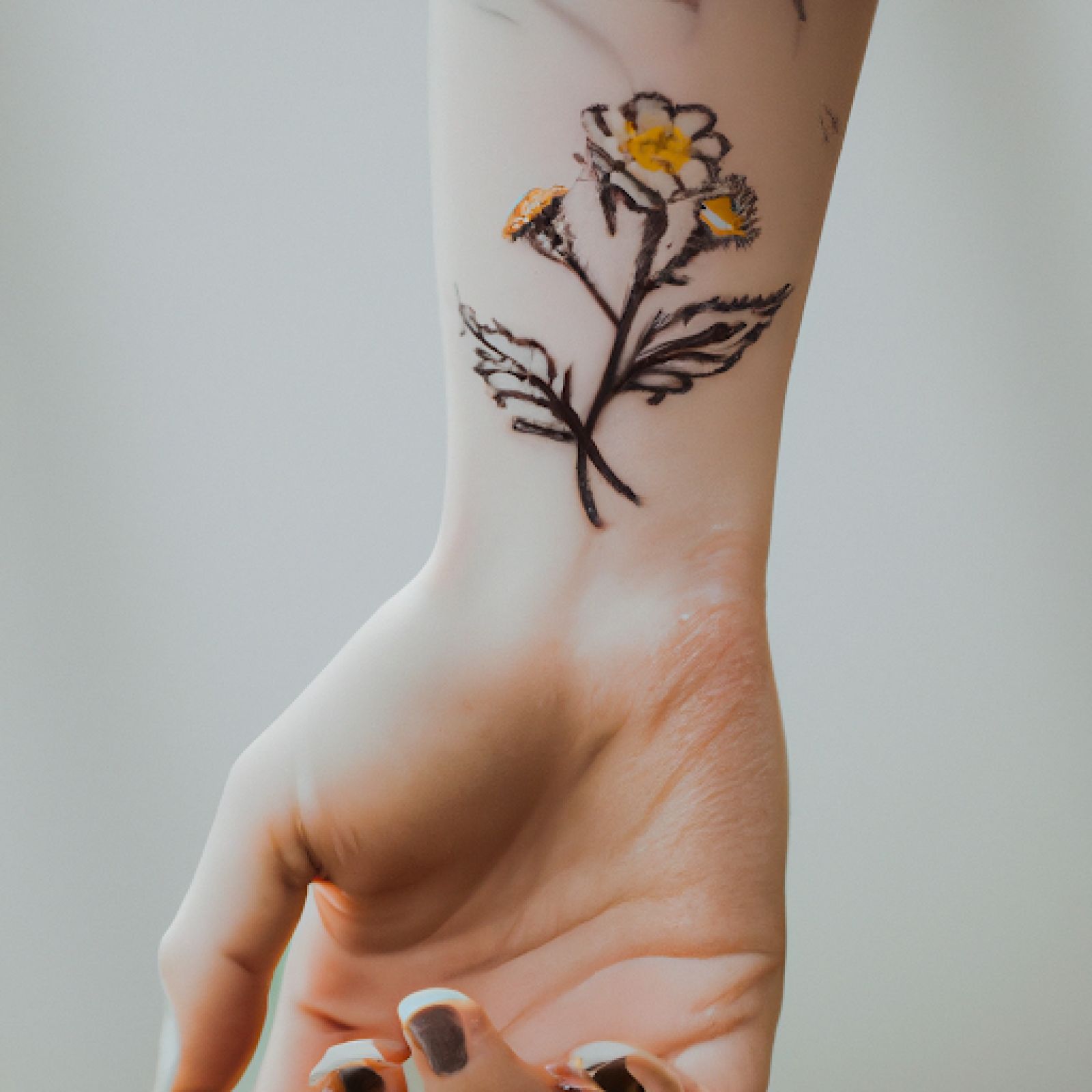 Flower tattoo on hand for women