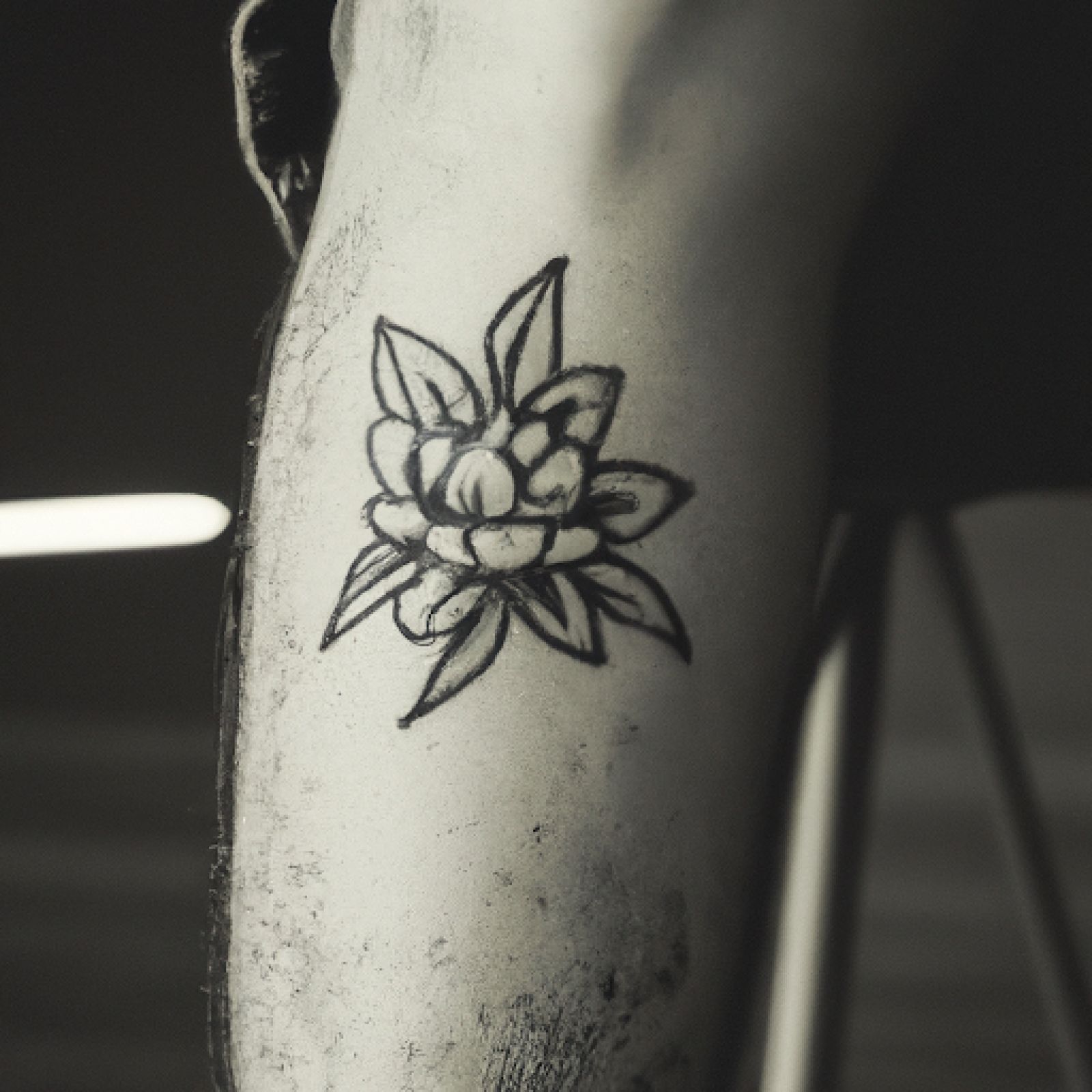 Flower tattoo on knee for men