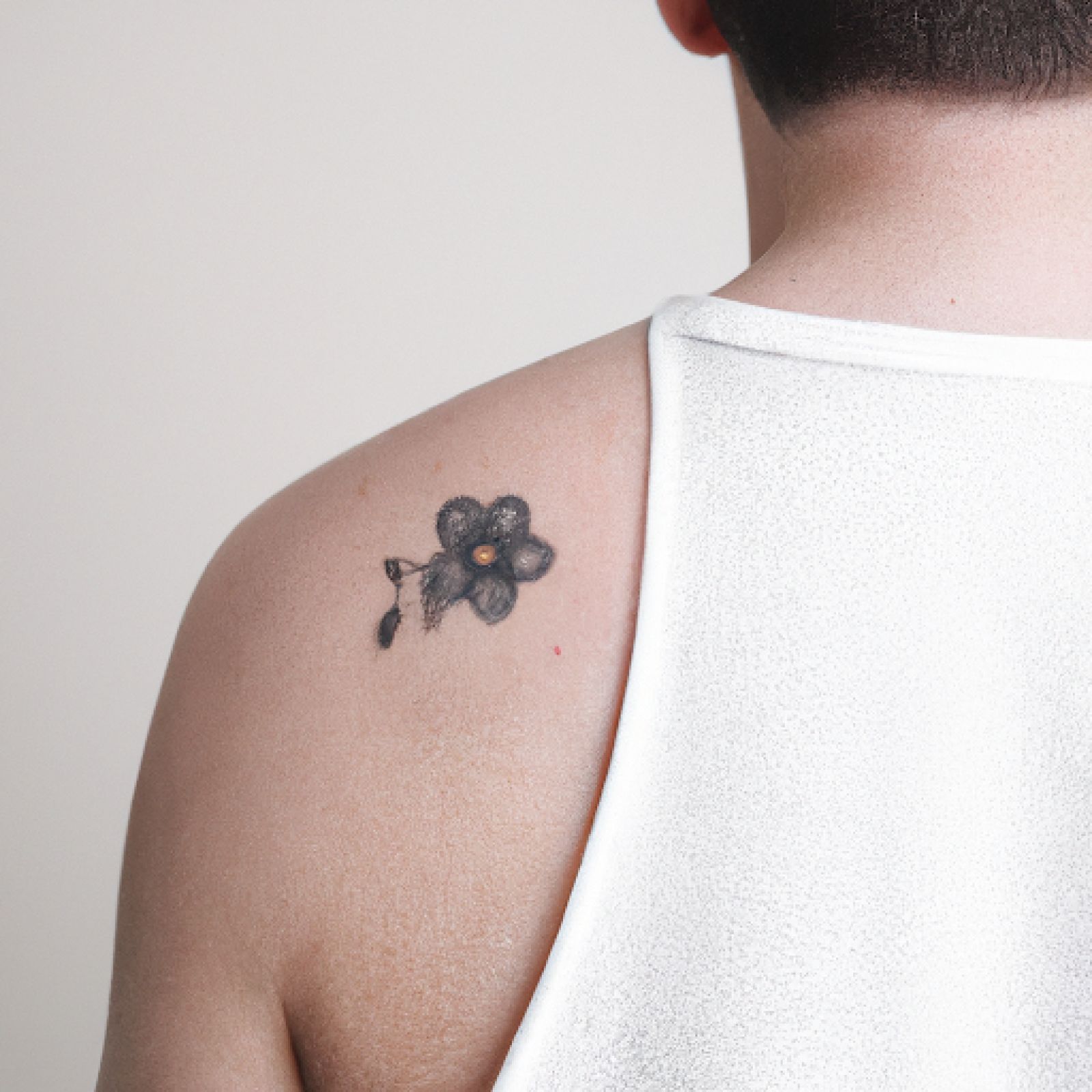 Flower tattoo on shoulder for men