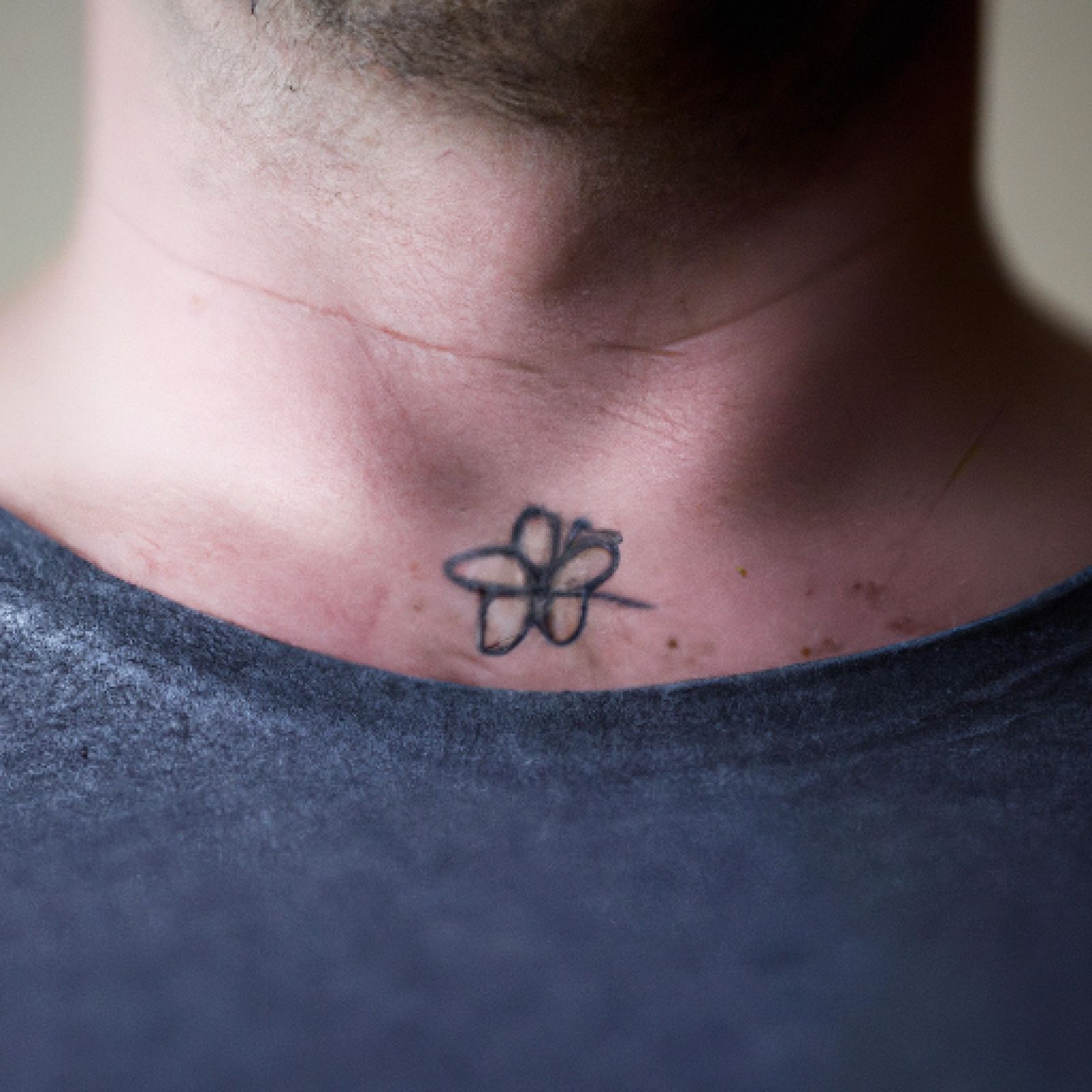 Flower tattoo on sternum for men