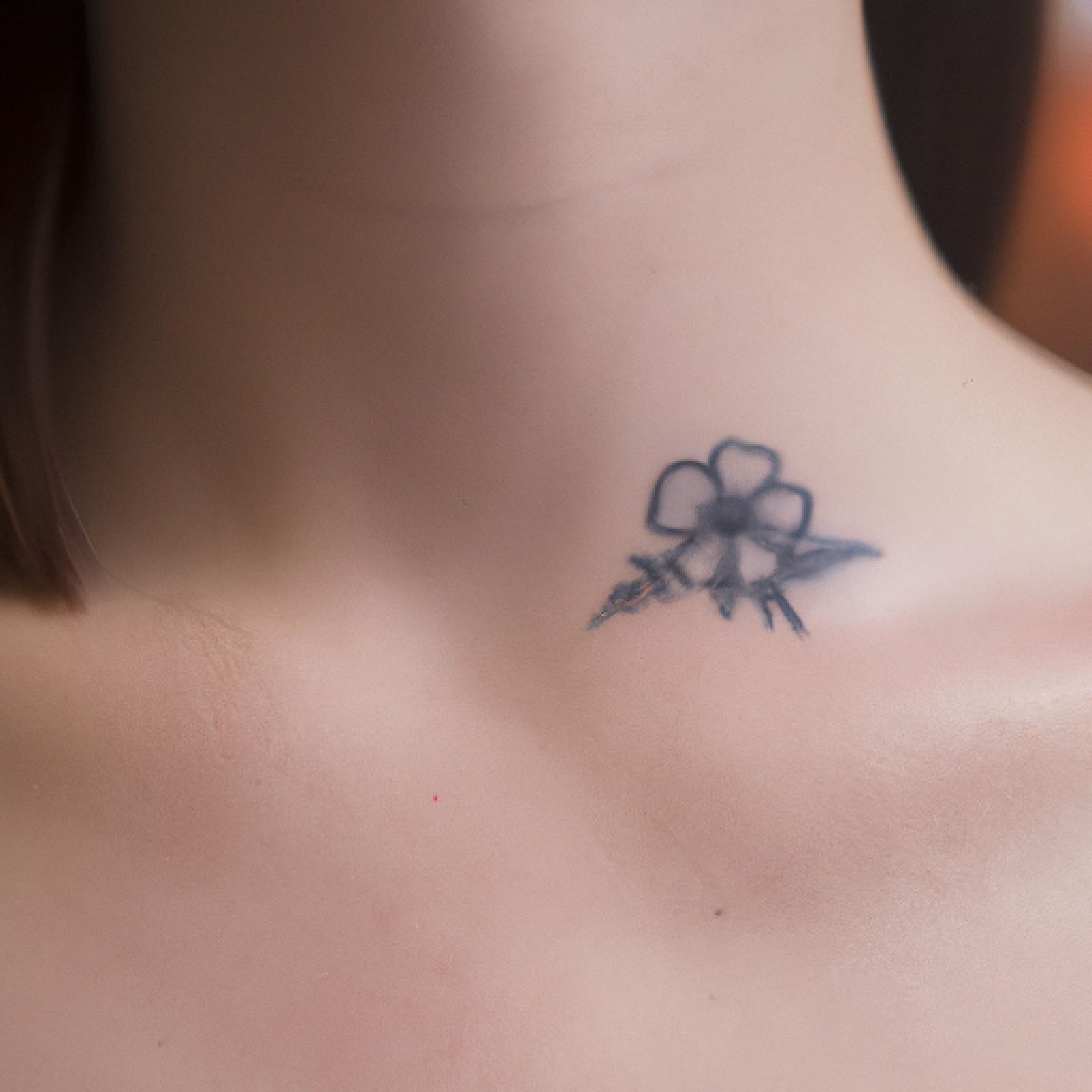 Flower tattoo on sternum for women