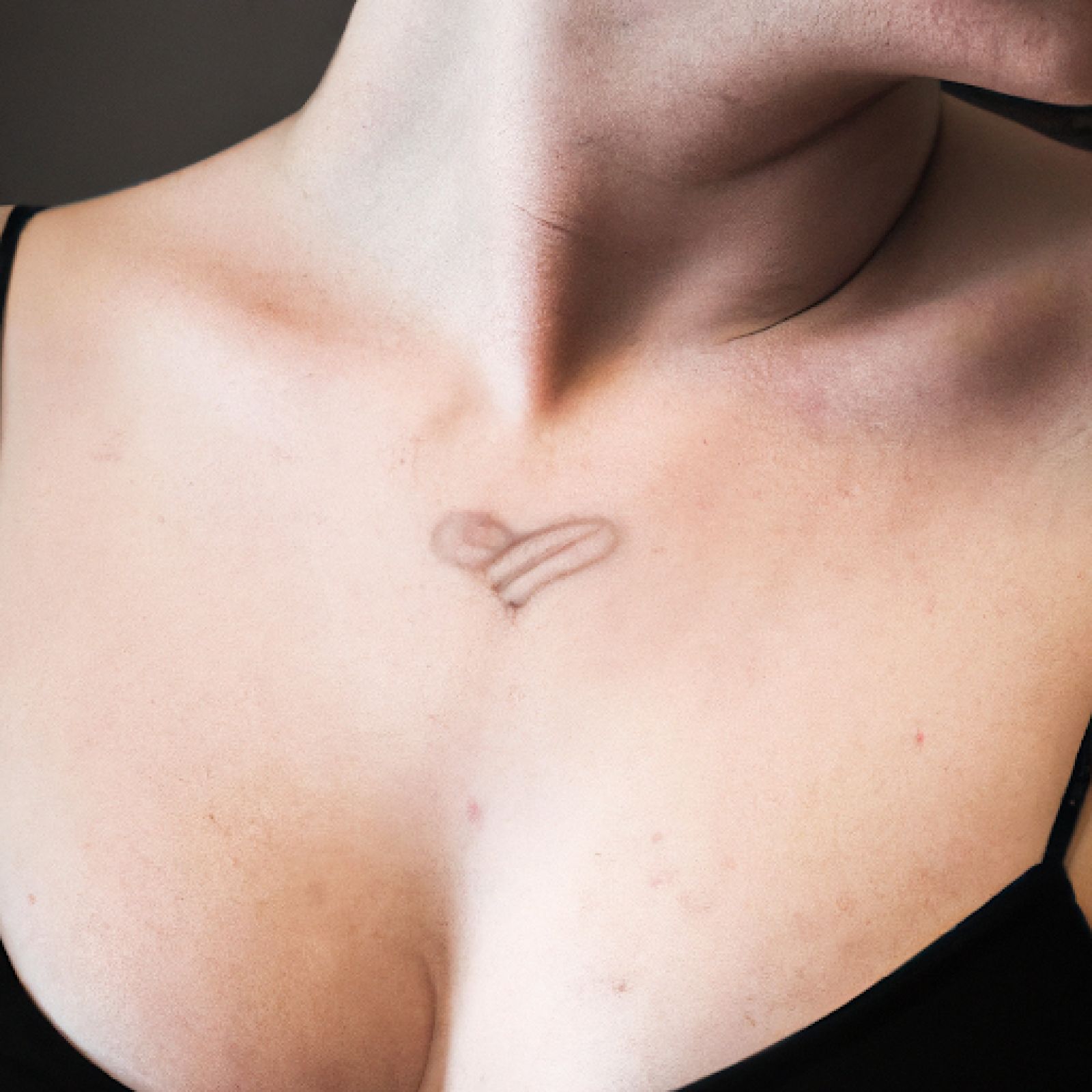 Heart tattoo on sternum for women