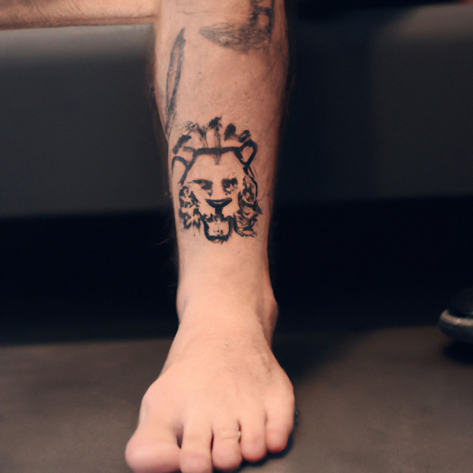 Lion tattoo on ankle for men