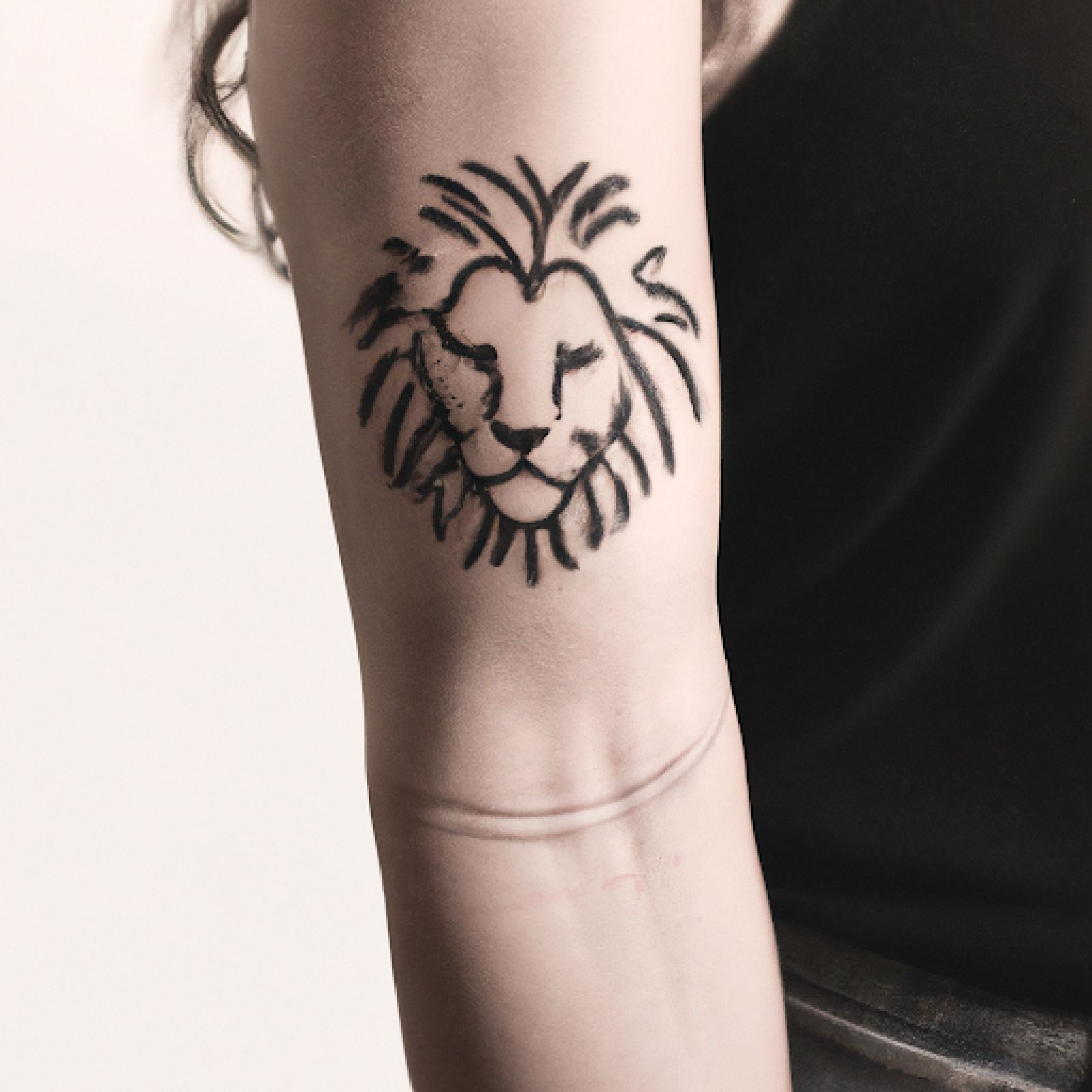 Lion tattoo on arm for women