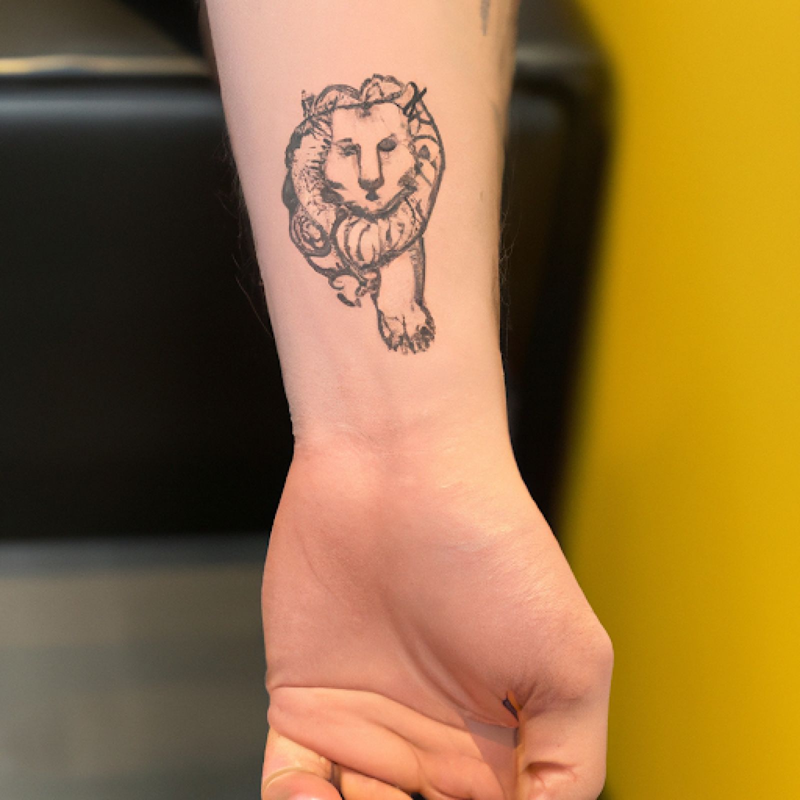 Lion tattoo on wrist for men