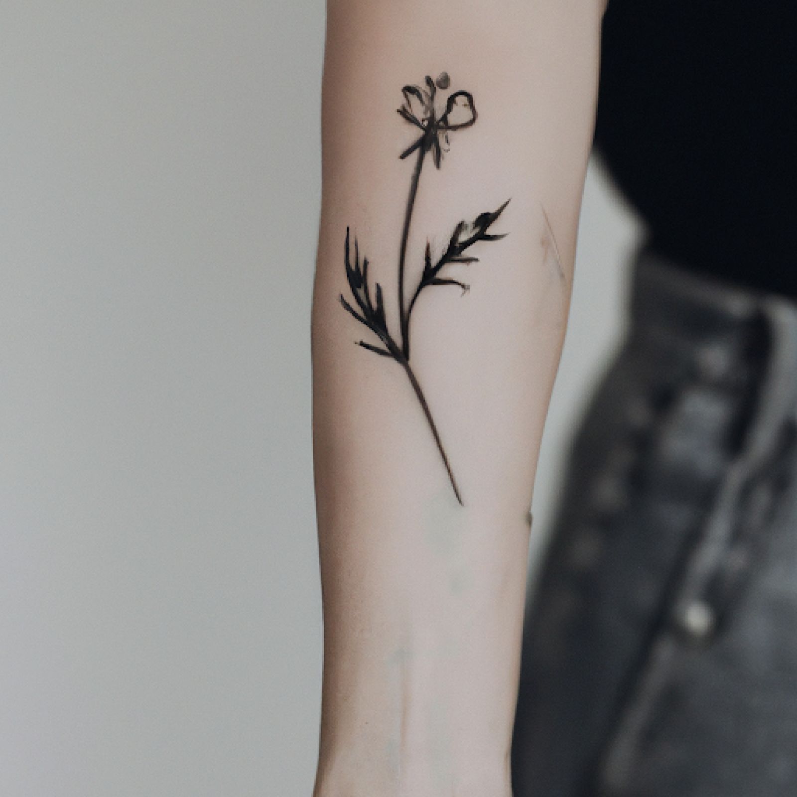 Tattoo of lotus-flower on arm for