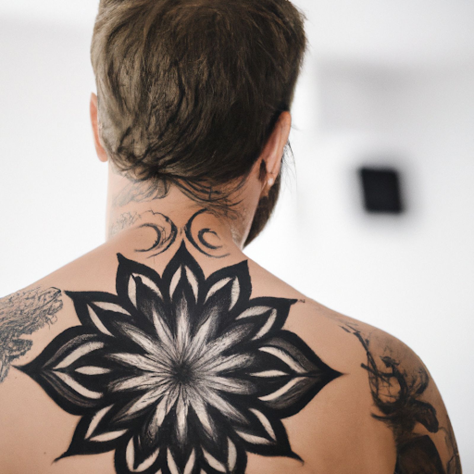 Mandala tattoo on back for men