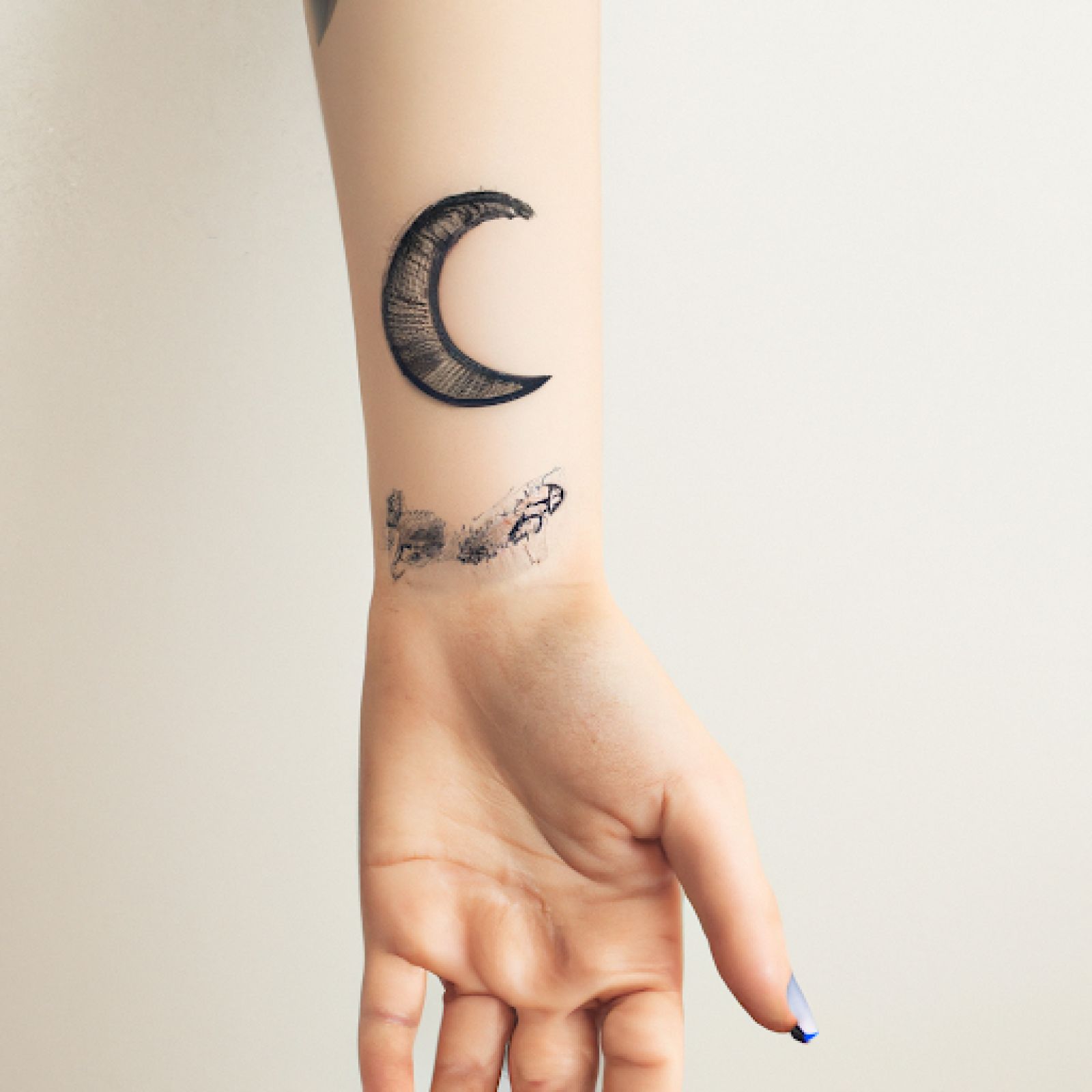Moon phases tattoo on hand for women