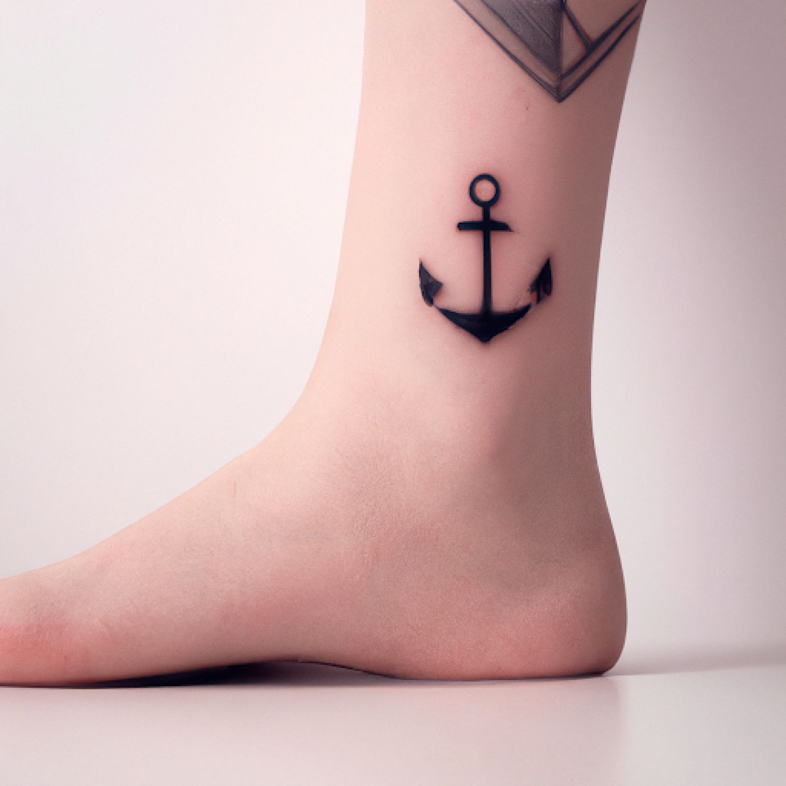 Ship tattoo on ankle for women