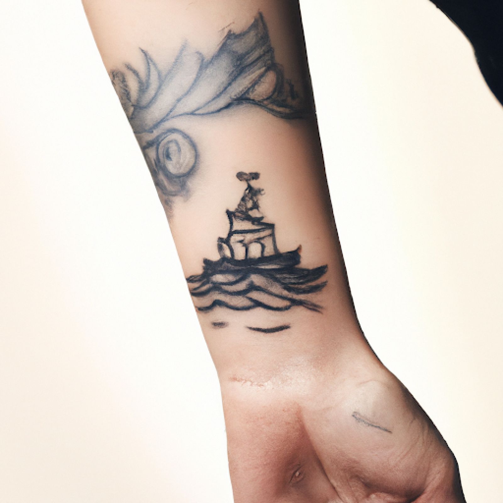 Ship tattoo on hand for women