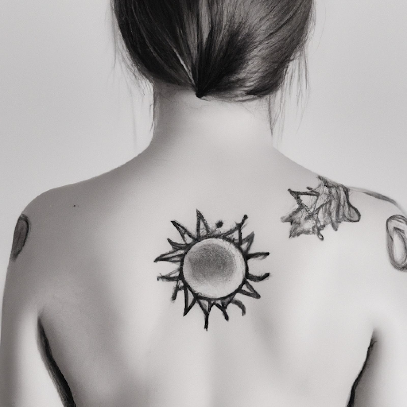 Sun tattoo on shoulder for women
