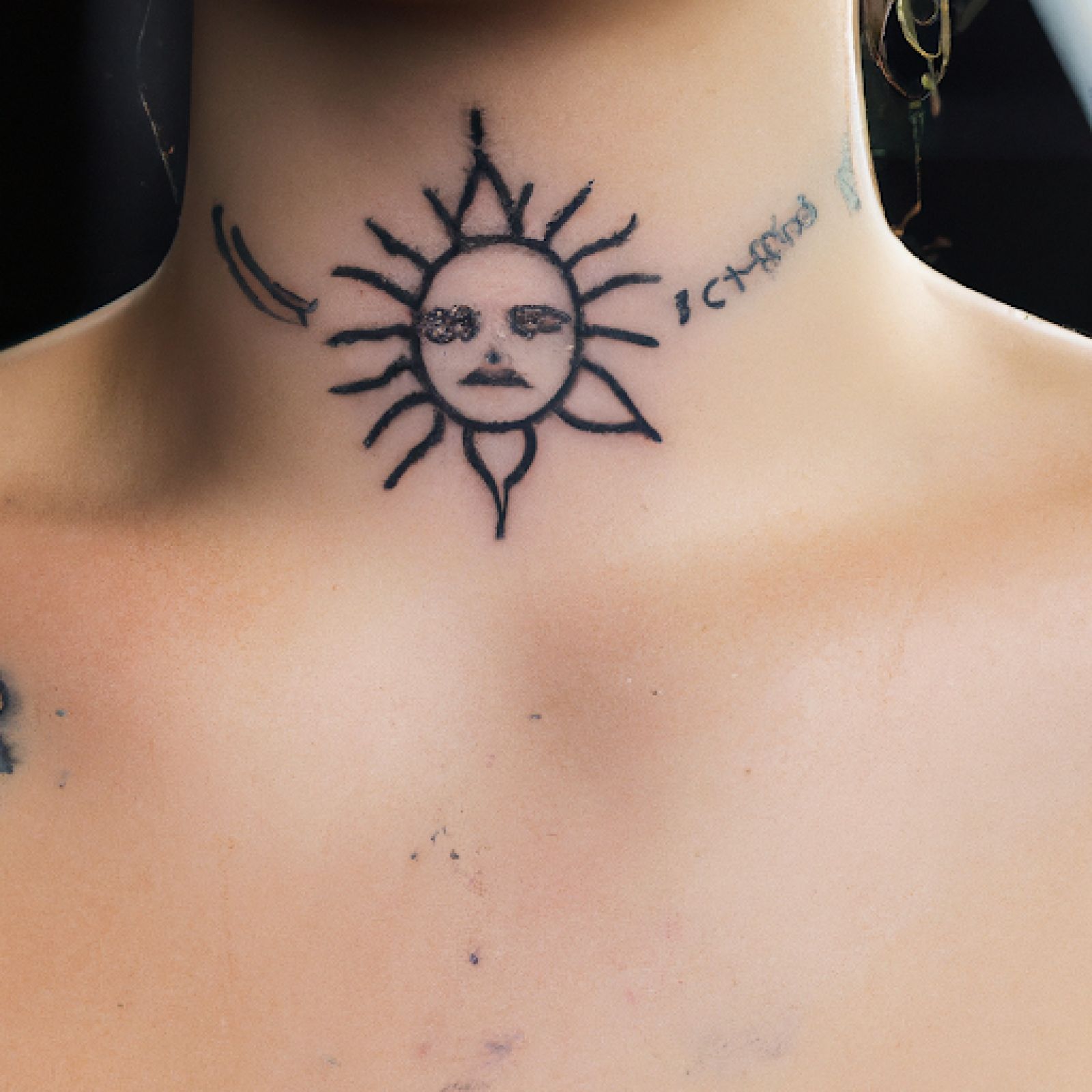 Sun tattoo on sternum for women