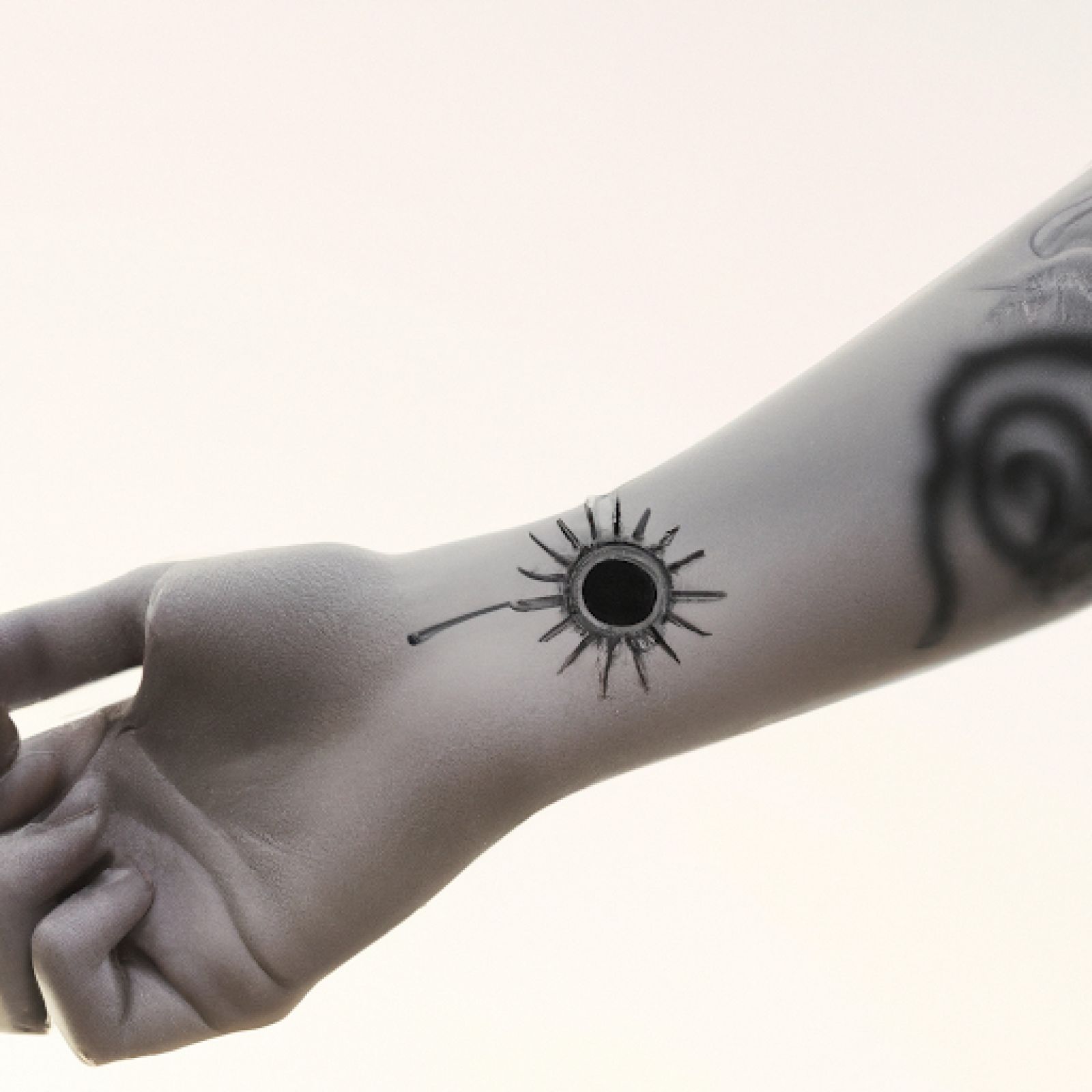 Sun tattoo on wrist for women