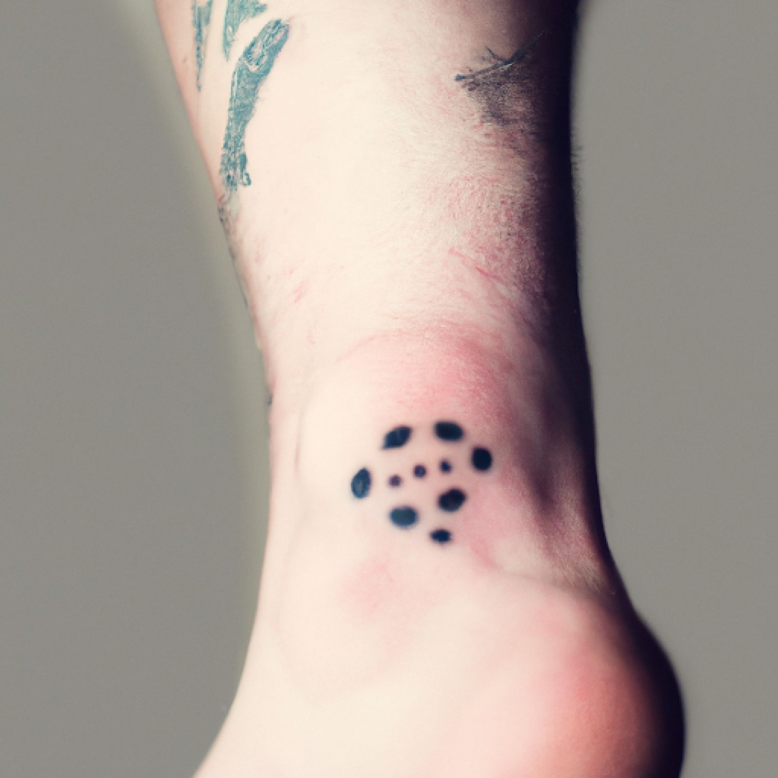 Trash polka tattoo on foot for men