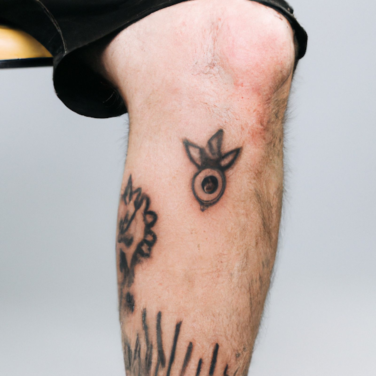 Trash polka tattoo on knee for men