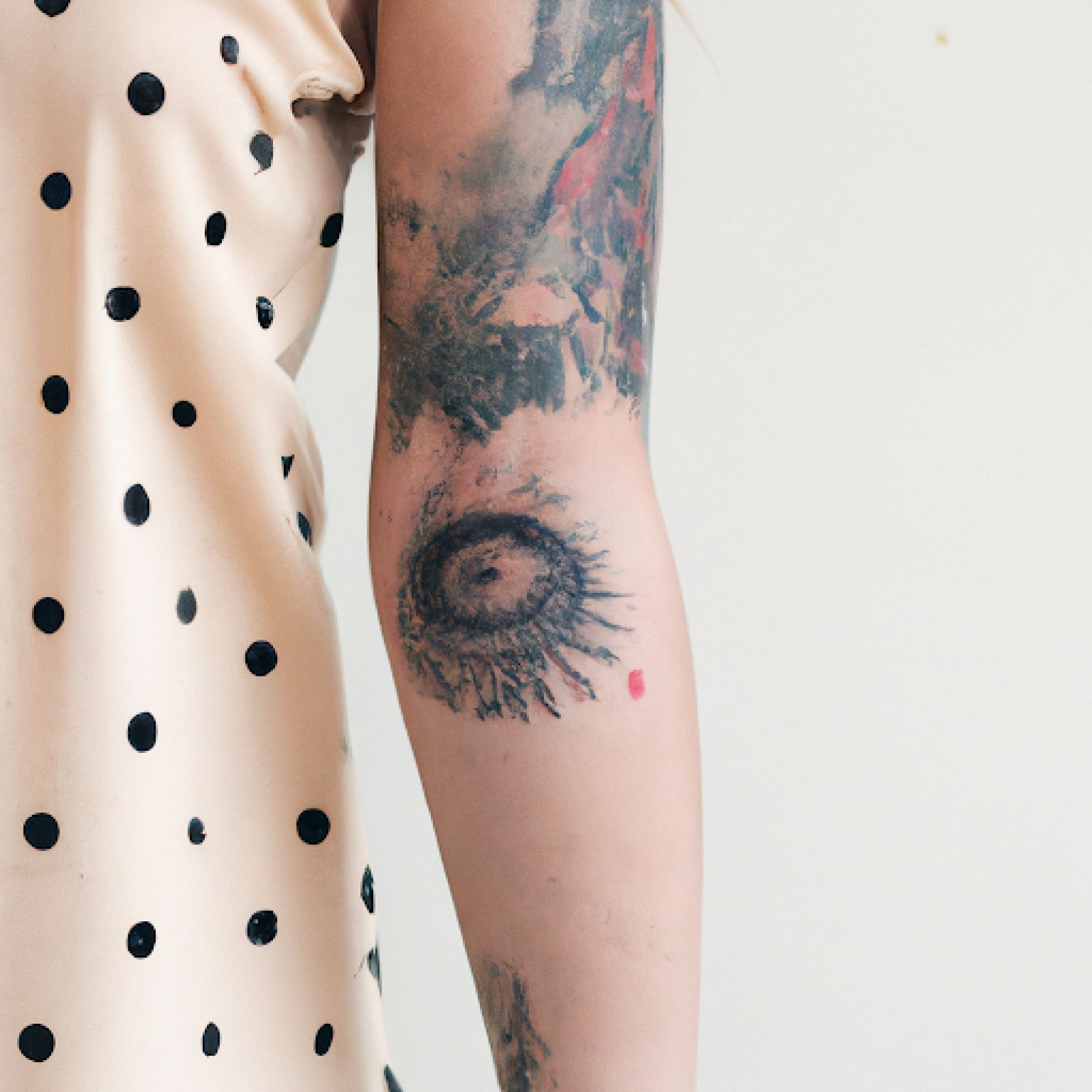 Trash polka tattoo on sleeve for women
