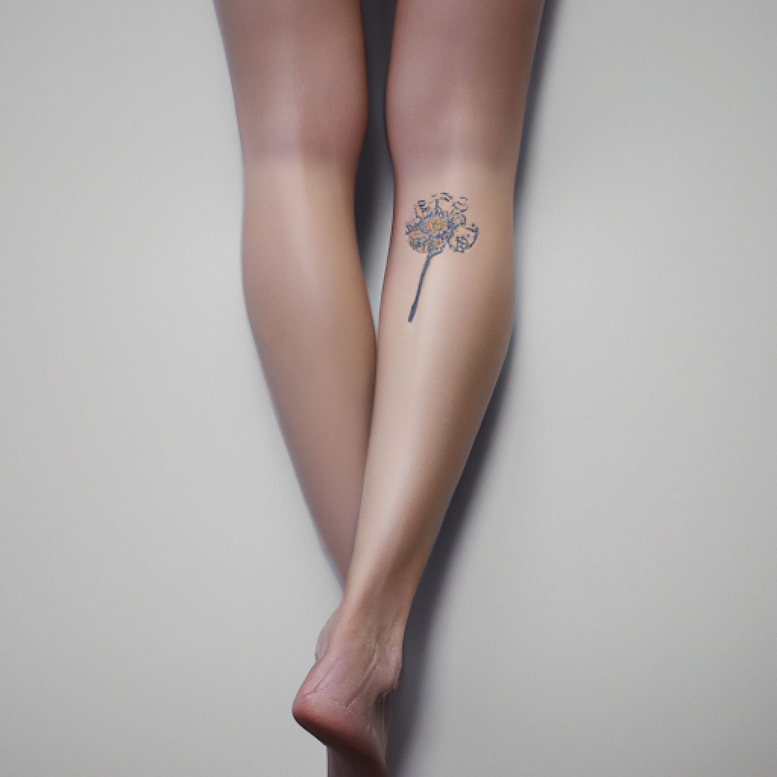 Watercolor tattoo on leg for women