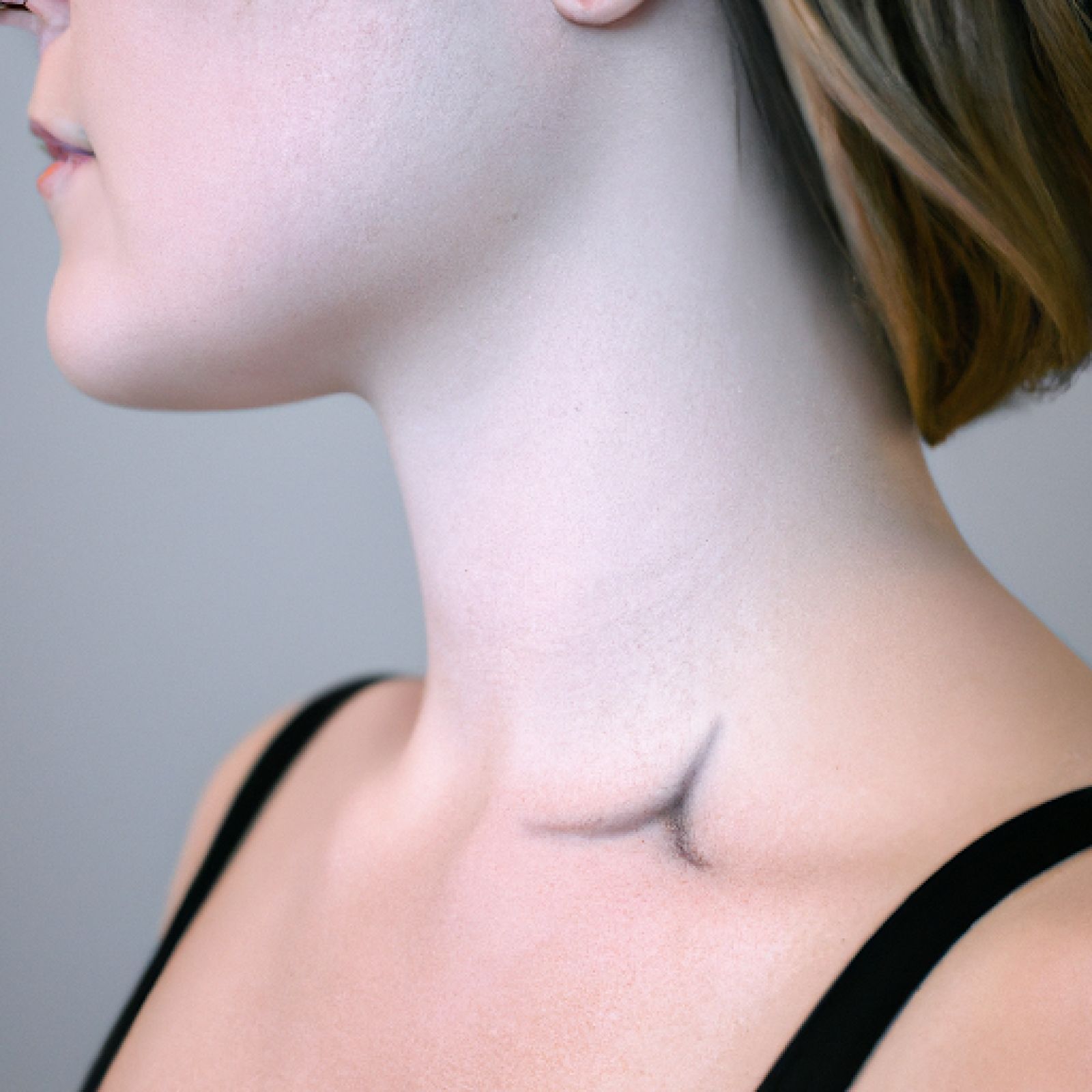 Watercolor tattoo on neck for women