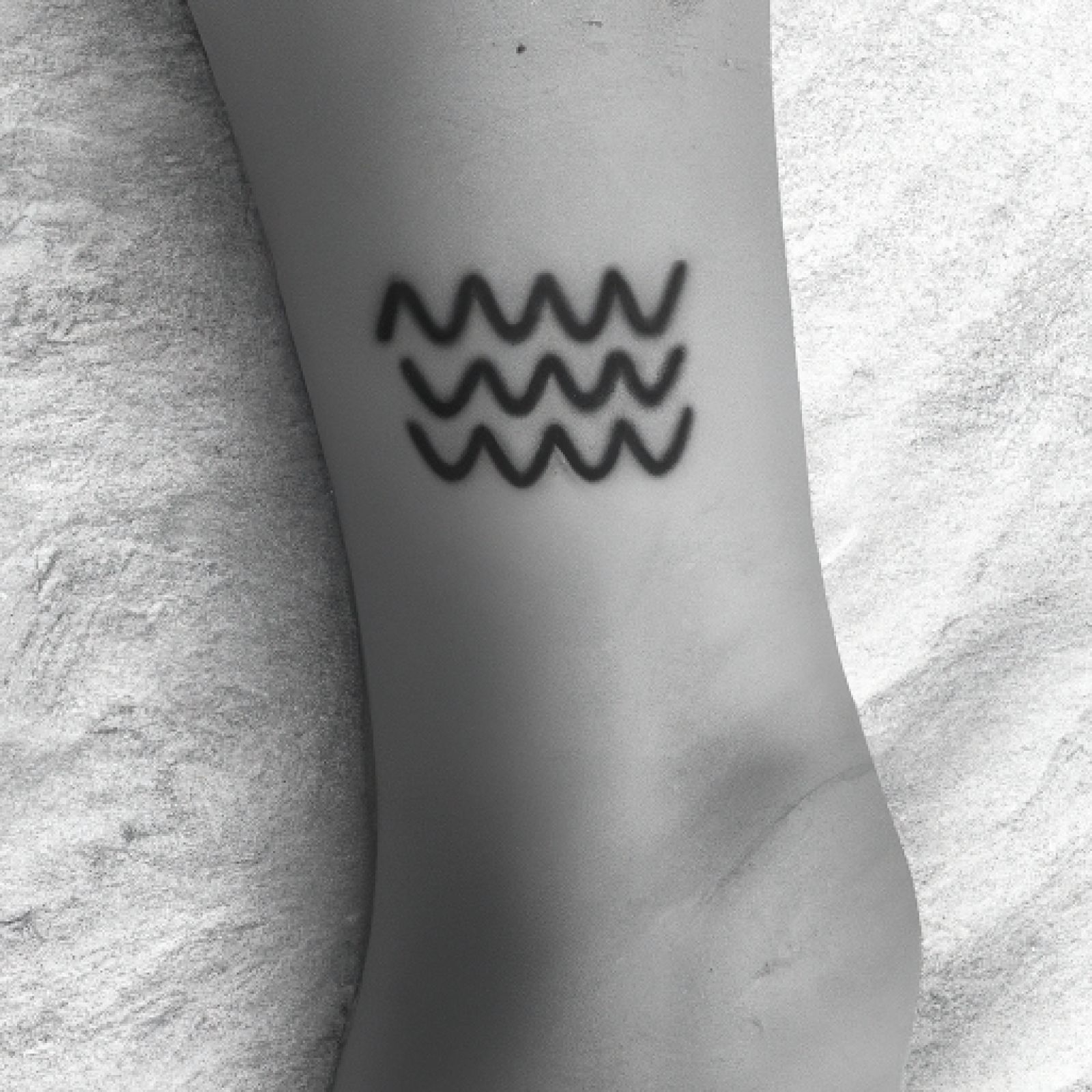 Wave tattoo on ankle for women