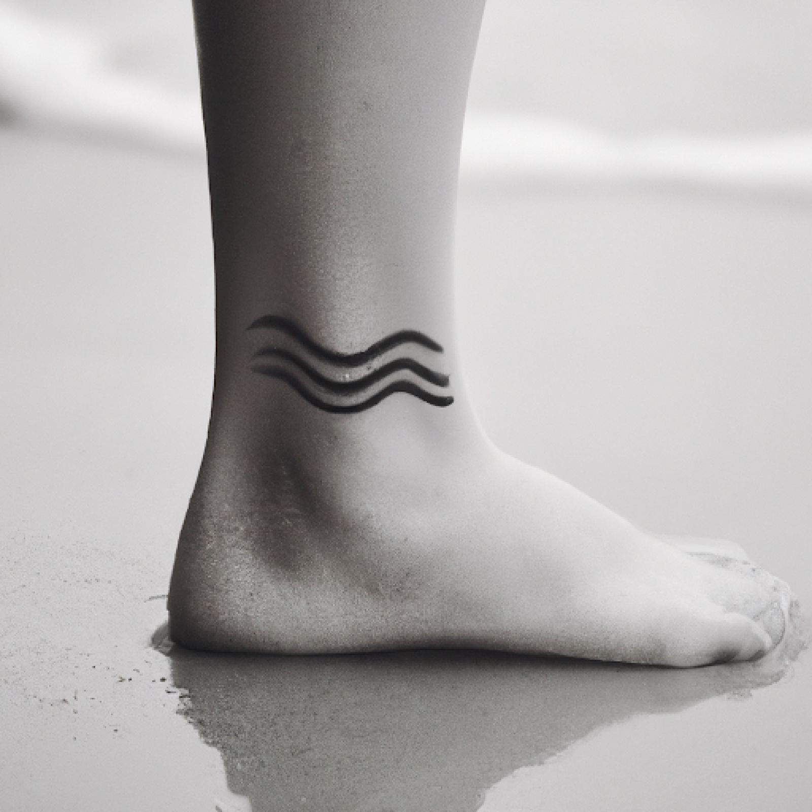 Wave tattoo on foot for women