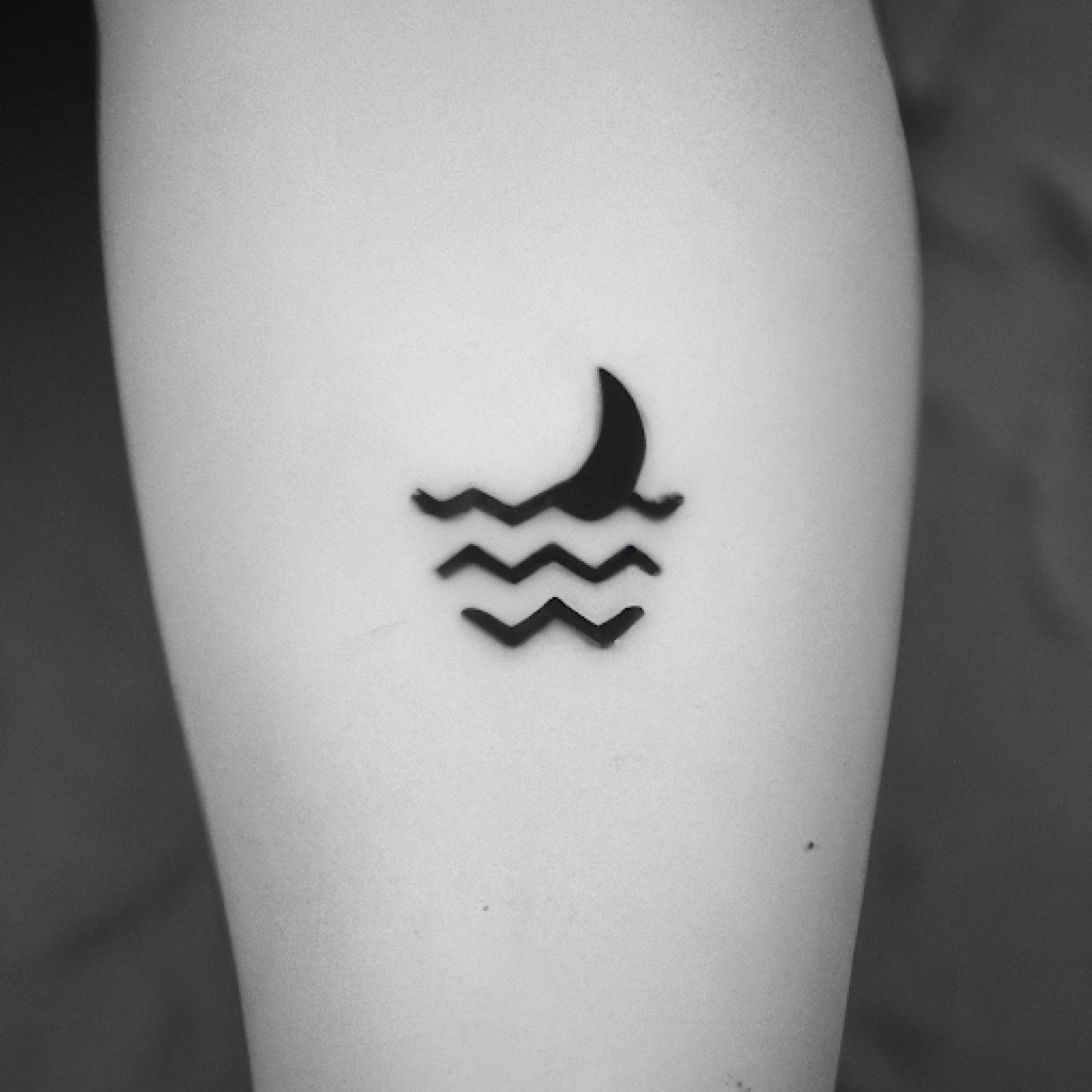 Wave tattoo on knee for women