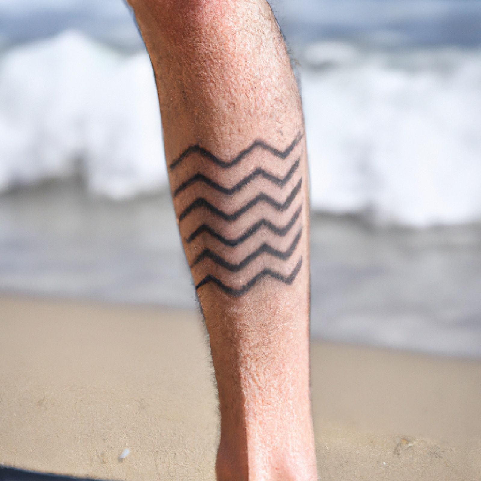 Wave tattoo on leg for men