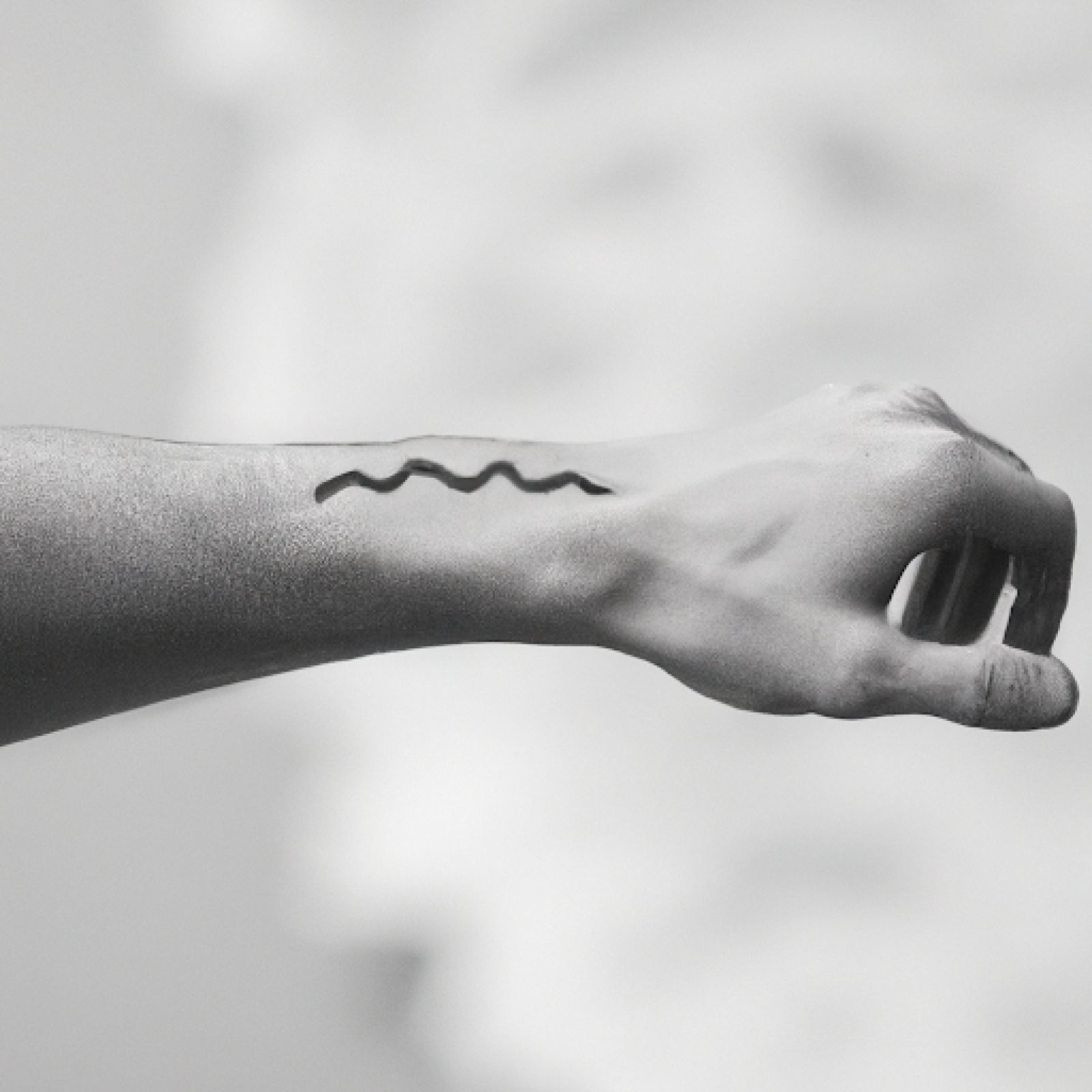 Wave tattoo on wrist for men