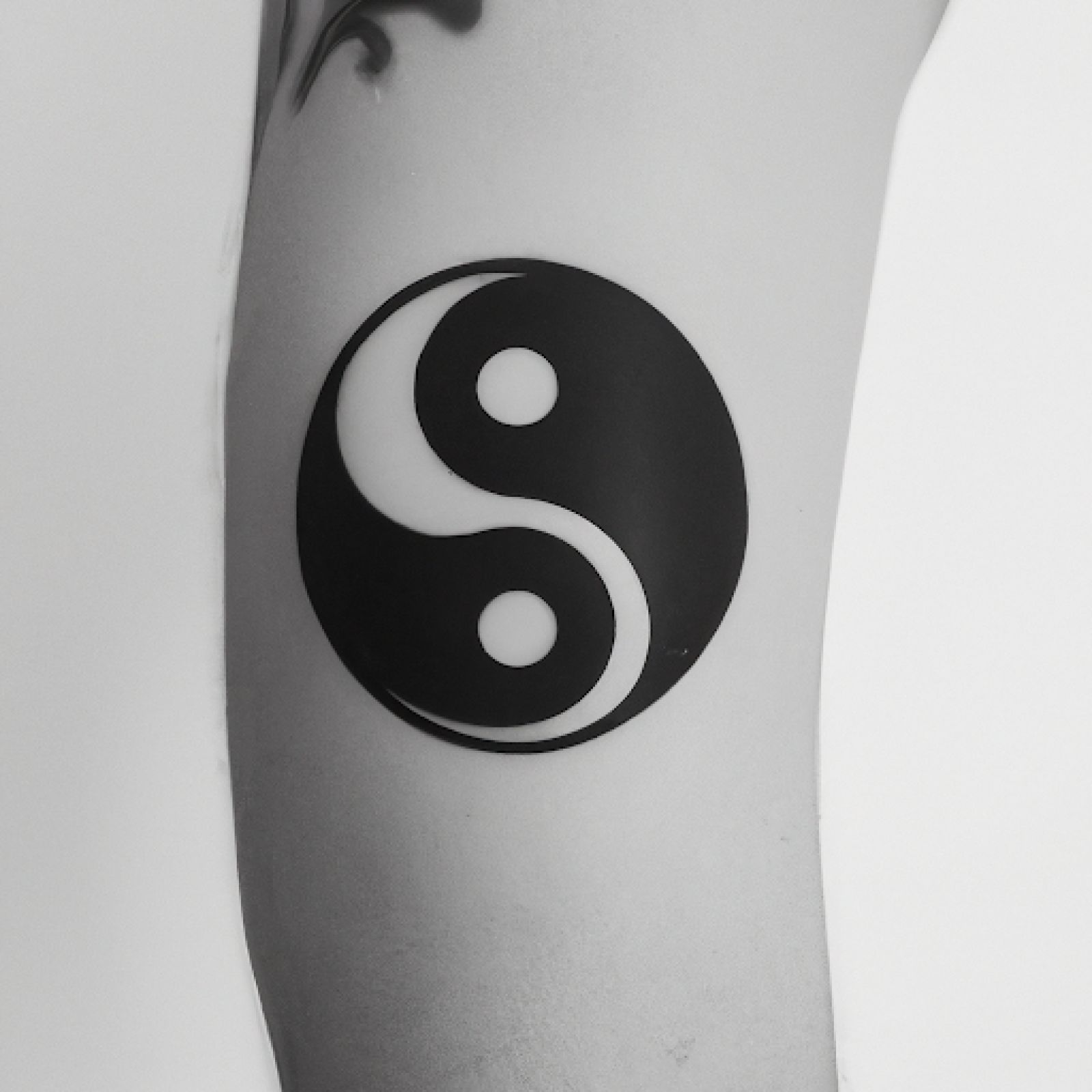 Yin yang tattoo on side for men