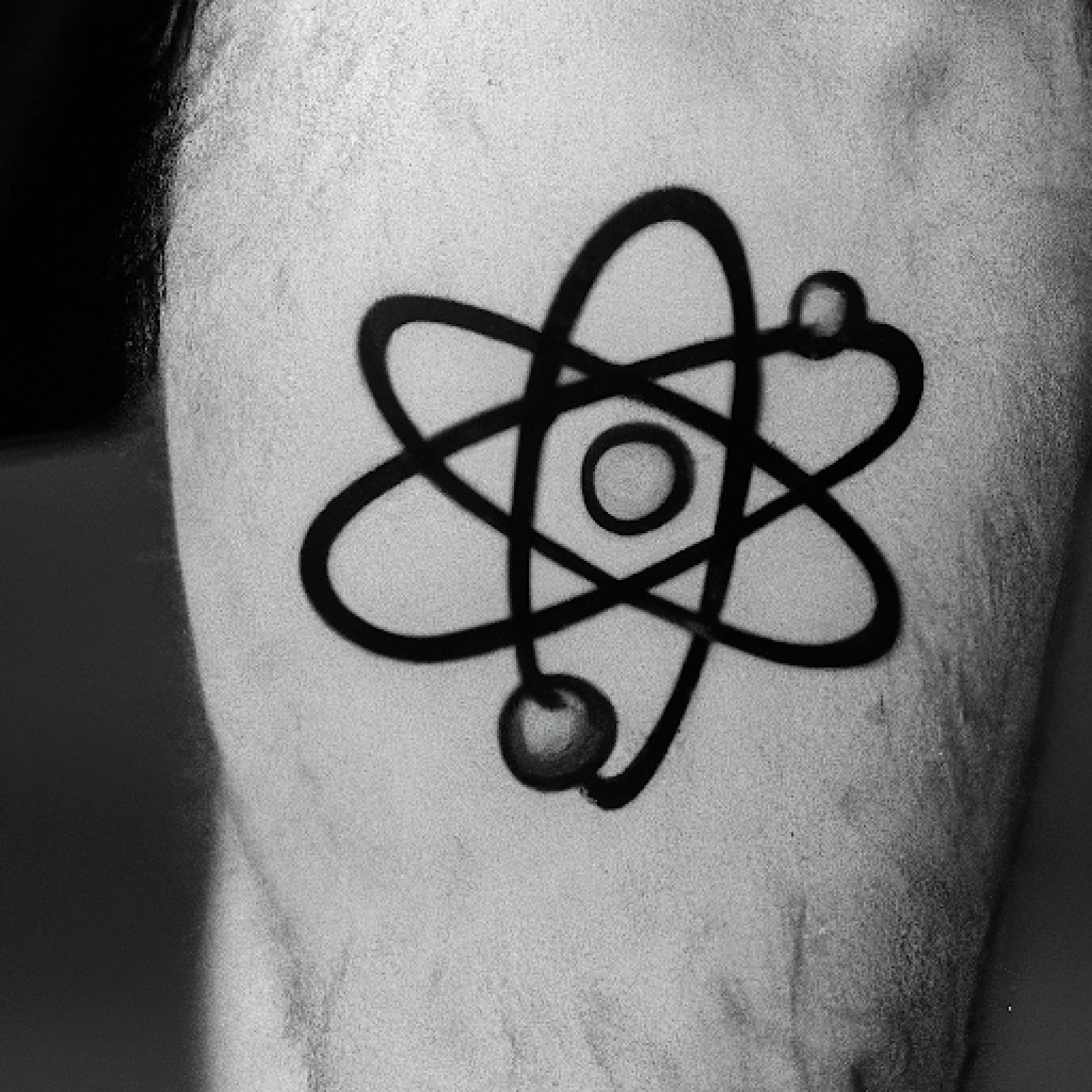 Atom tattoo on calf for men