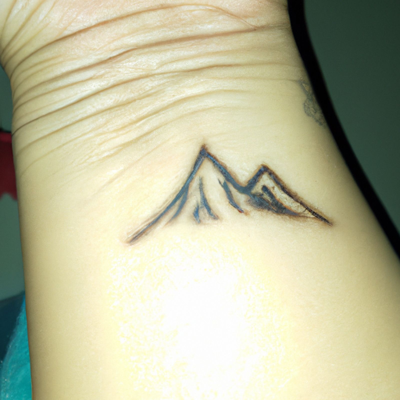 Mountain tattoo on hand for women