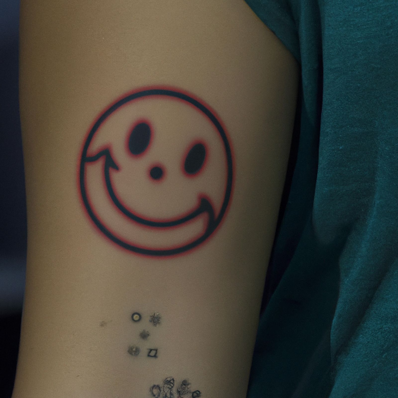 Smiley tattoo on half sleeve for women