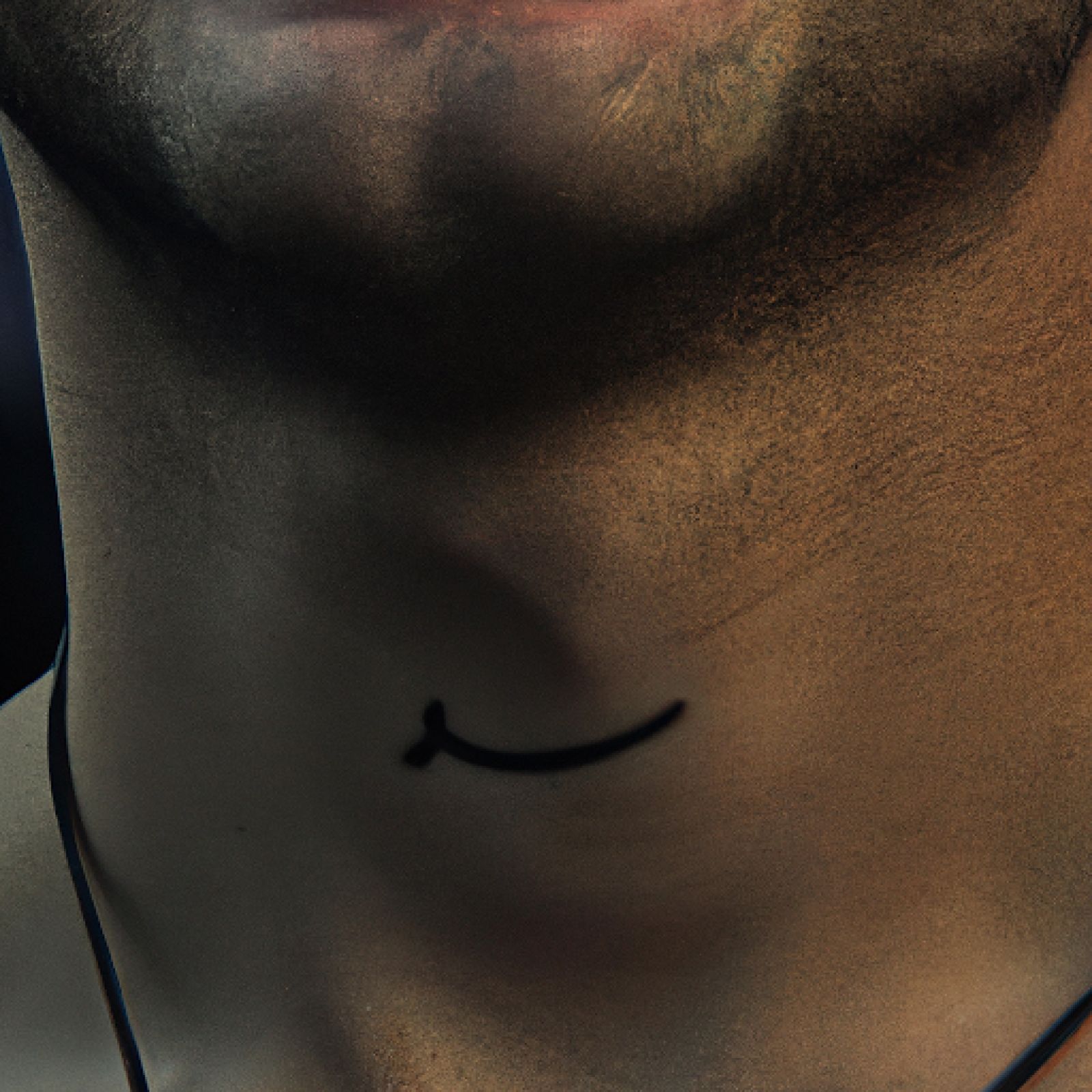 Smiley tattoo on neck for men