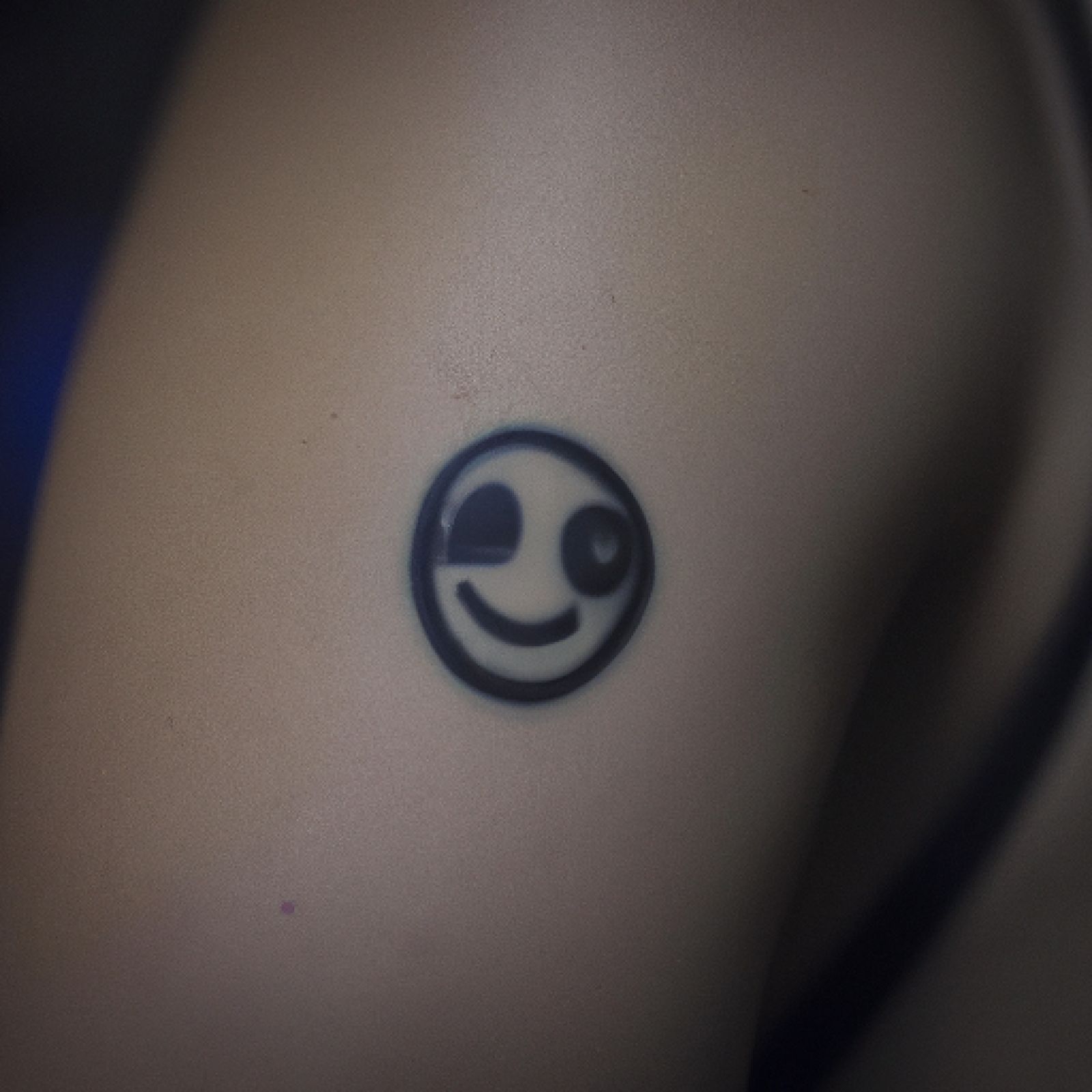 Smiley tattoo on side for women