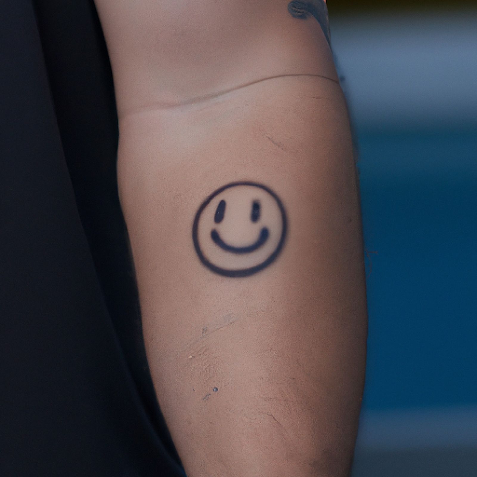 Smiley tattoo on sleeve for men