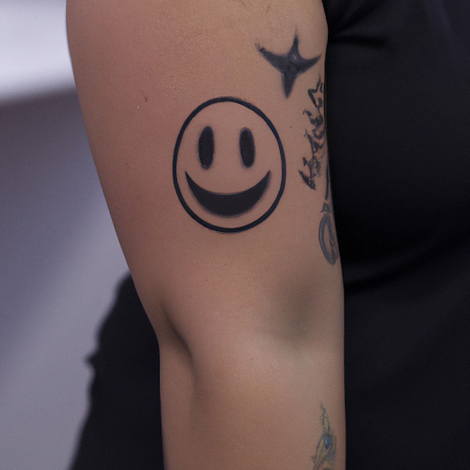 Smiley tattoo on sleeve for women